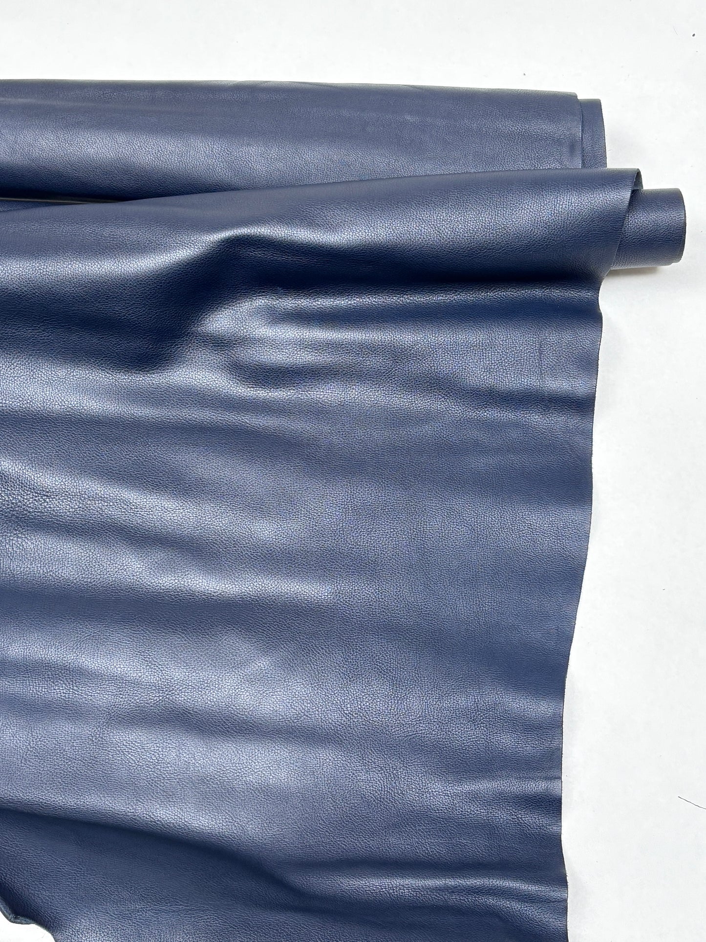 Large blue leather piece is shown on a white background