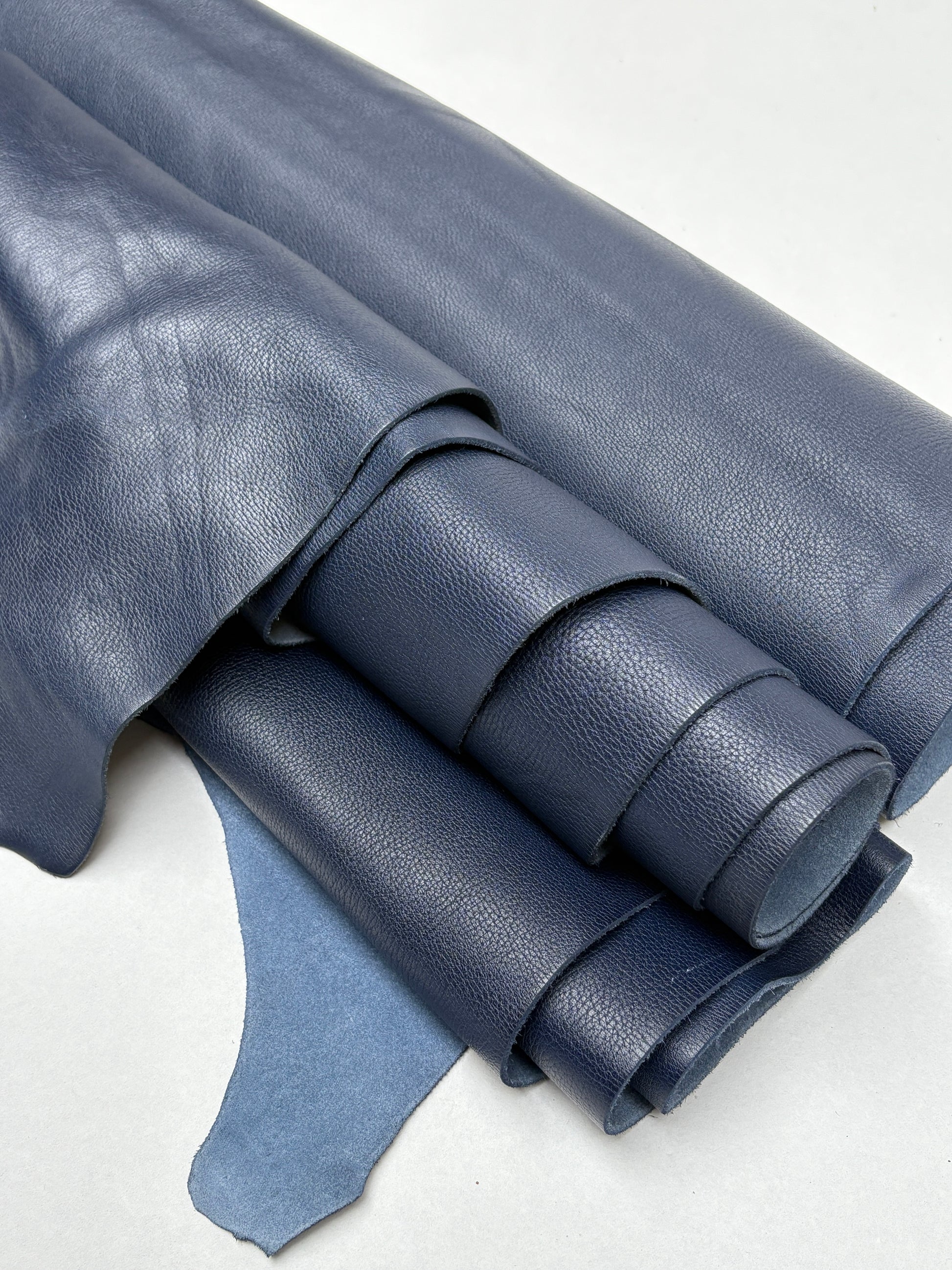 Close-up of blue leather rolls shows a soft grain texture