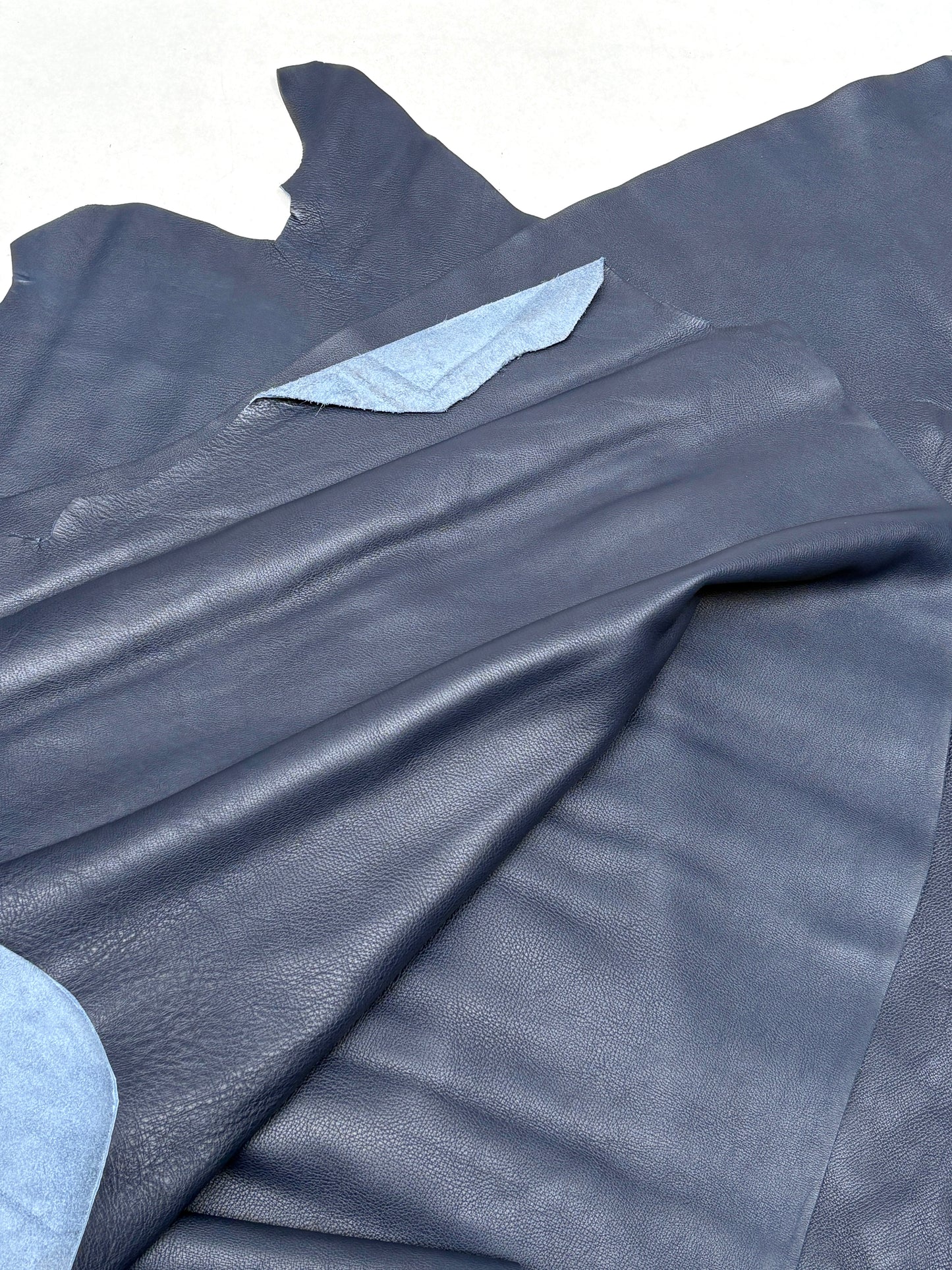Detailed view of blue leather highlights its smooth finish