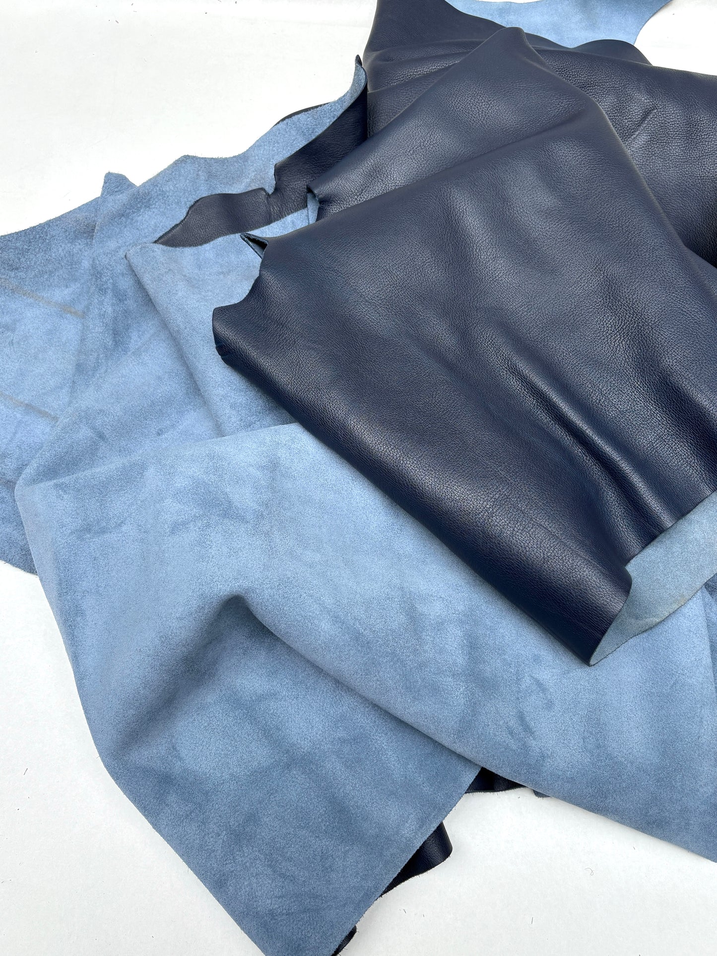 Surface detail of blue leather shows a lightly wrinkled texture