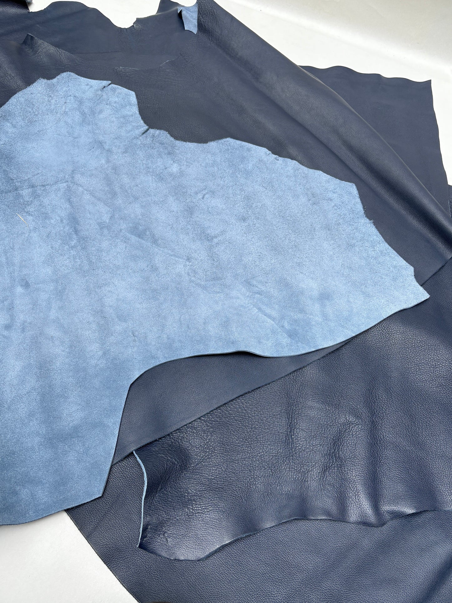 Close-up blue leather detail reveals a soft matte sheen