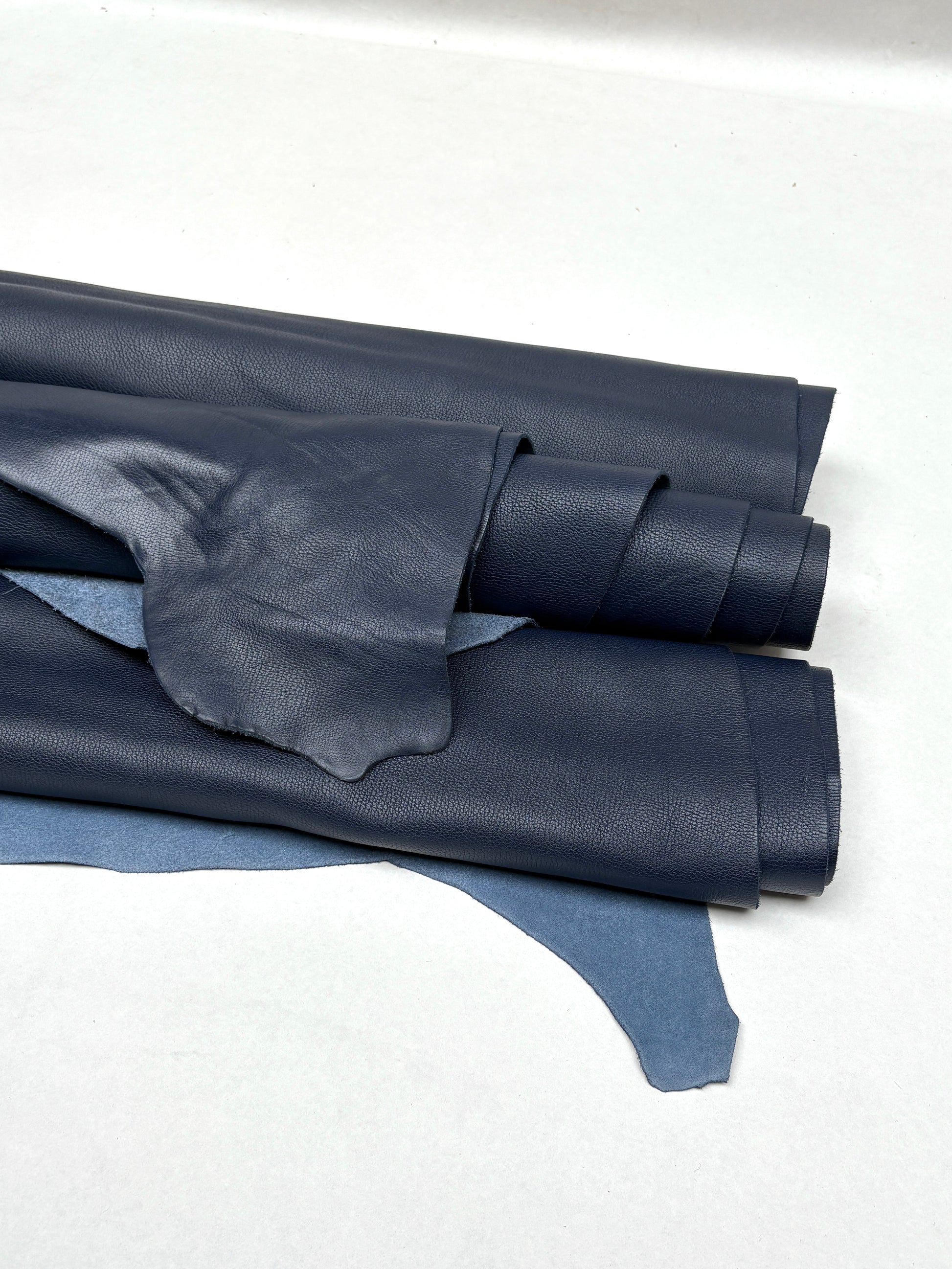 Rolled blue leather is shown with visible grain texture
