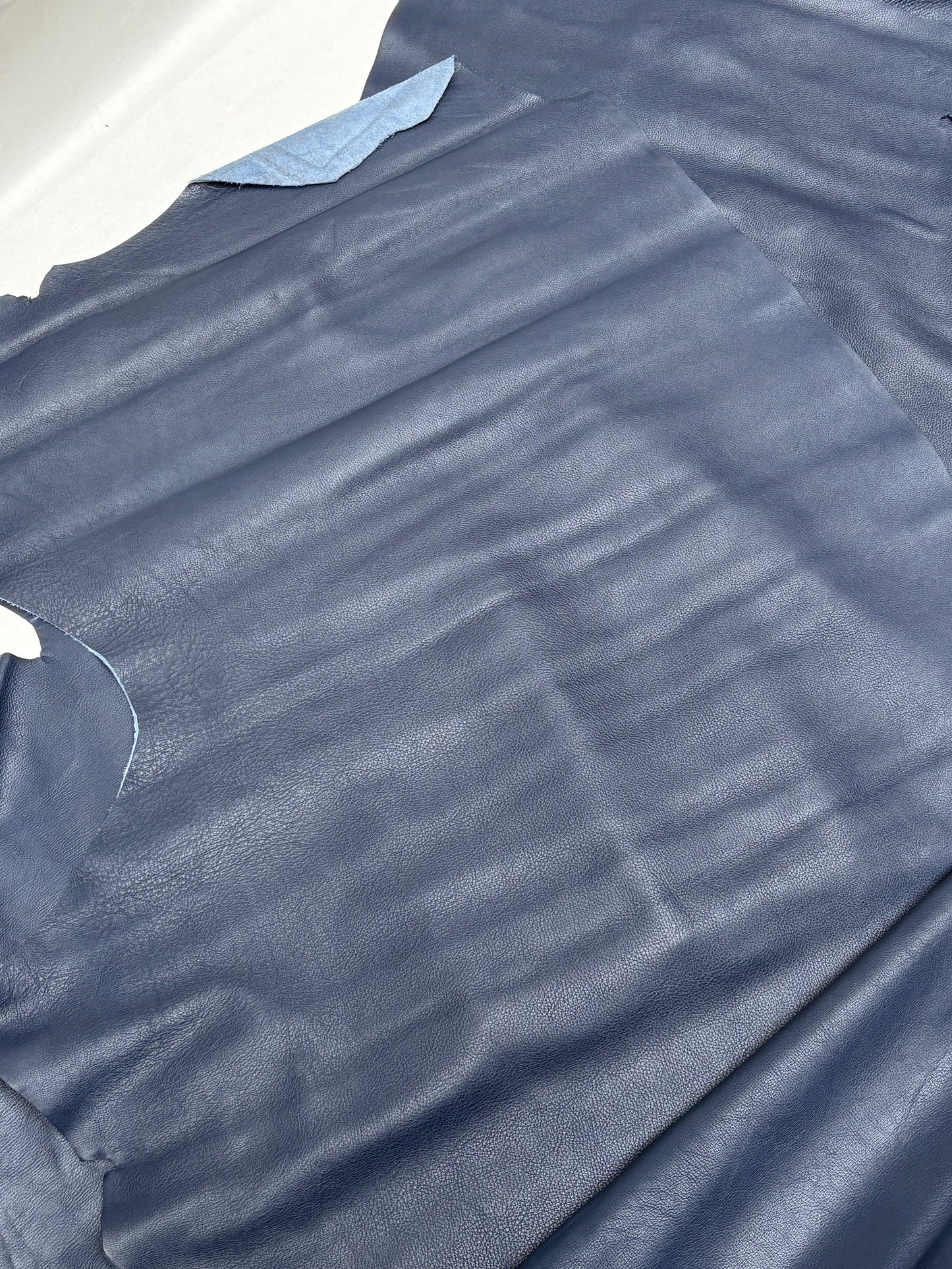 Soft blue leather pieces with uneven natural edges