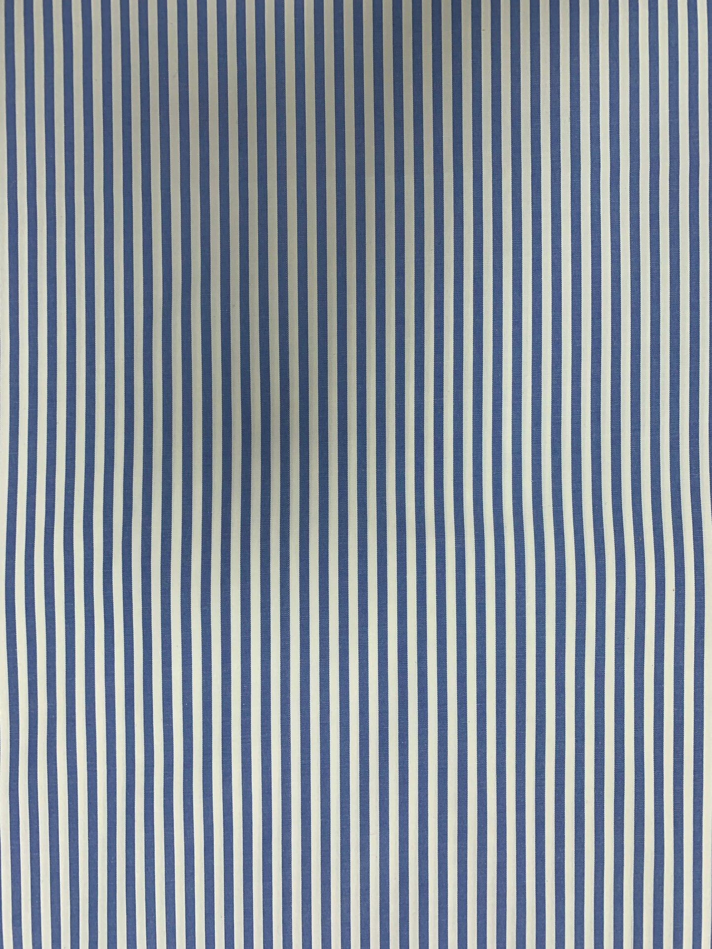 Close surface view of light blue-white striped shirting fabric.