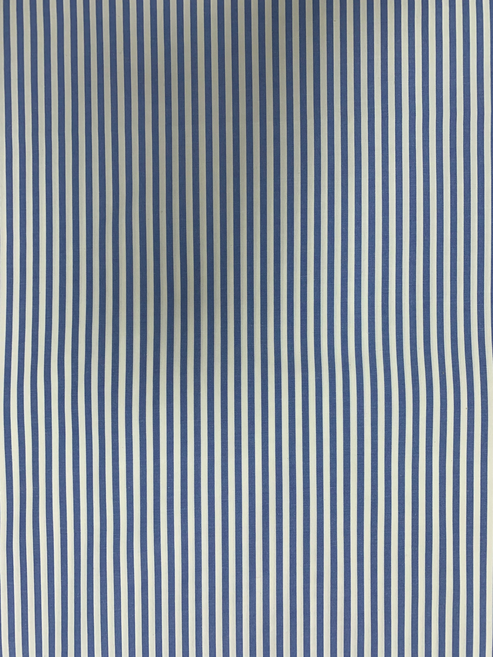 Close surface view of light blue-white striped shirting fabric.