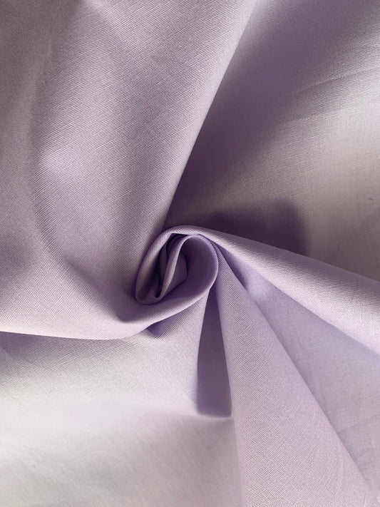Lilac cotton fabric is folded into a soft central twist