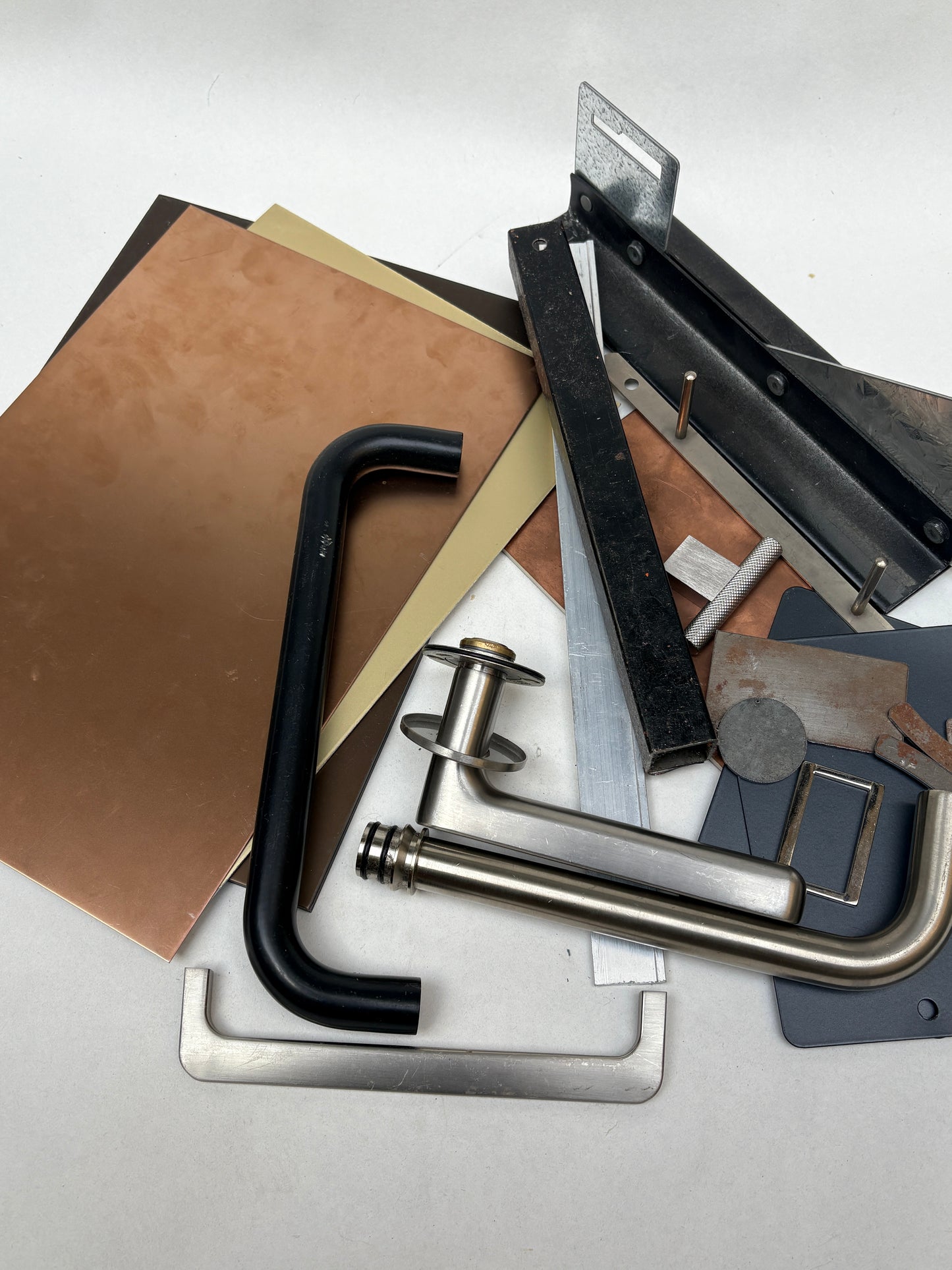 Metal scraps and sample pieces are displayed on a white background