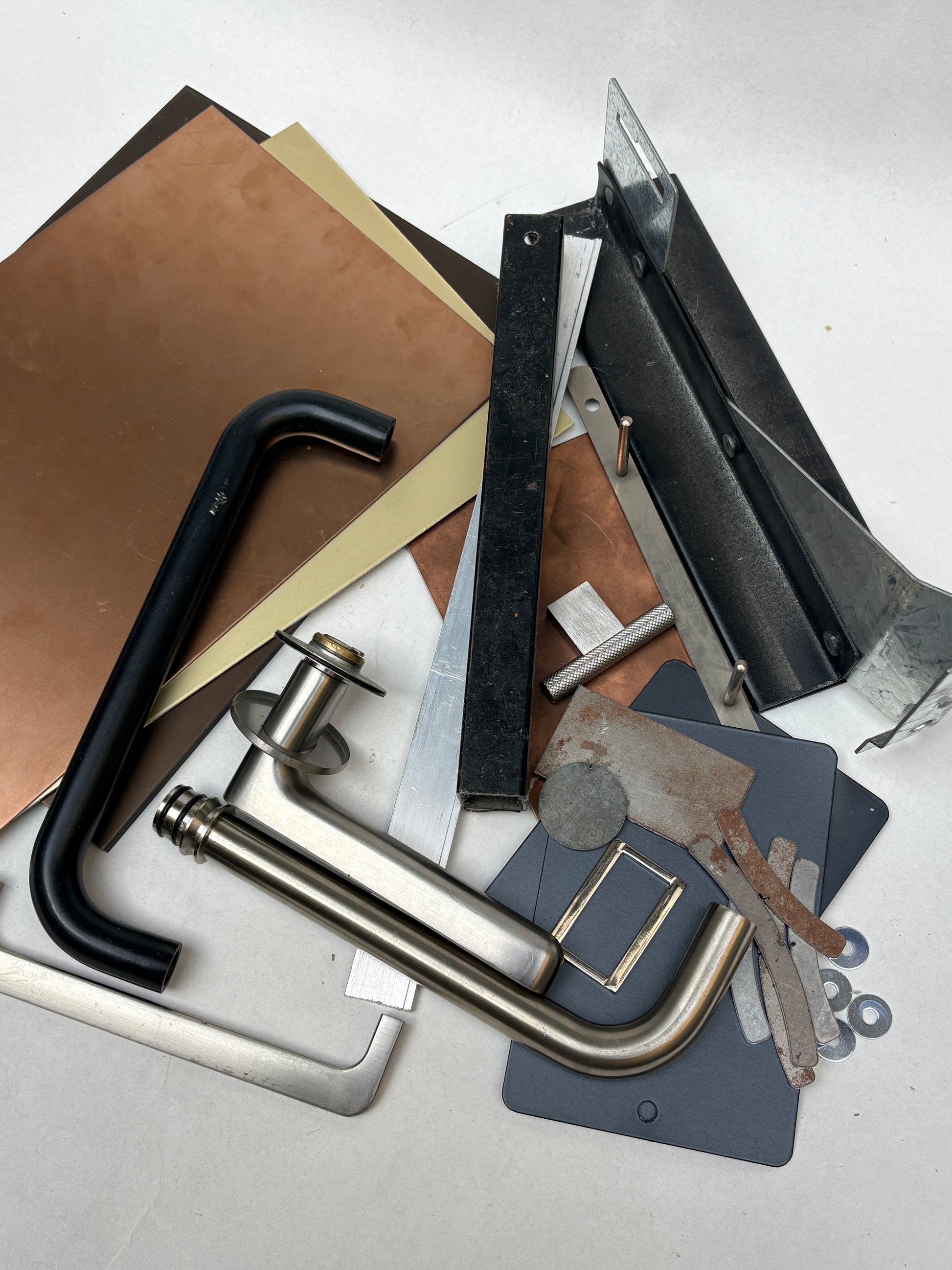 Metal scraps and sample pieces are displayed on a white background