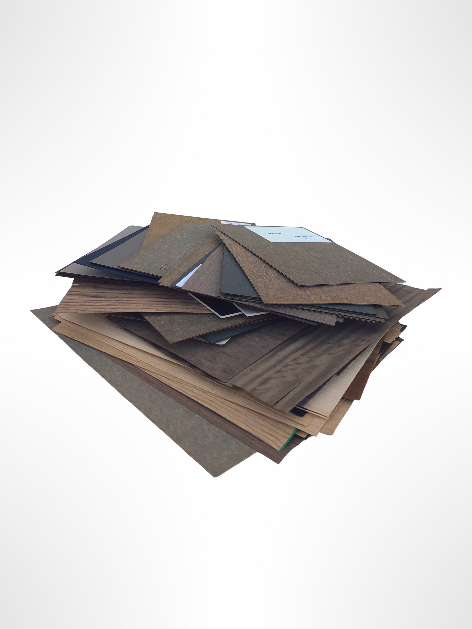Layered sample panels show varied woodgrain and dark surface finishes