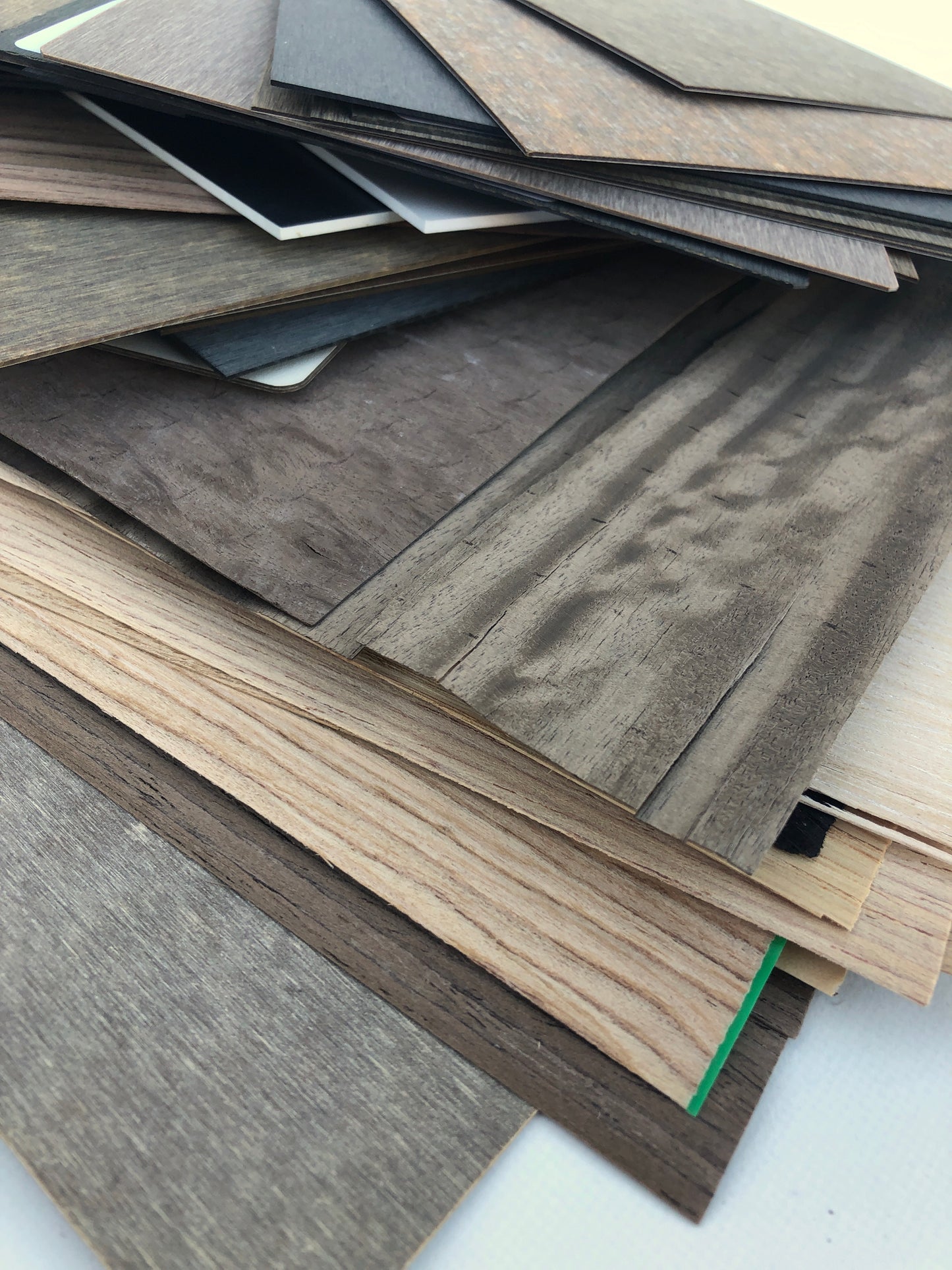 Close-up view shows stacked boards in different brown and grey tones