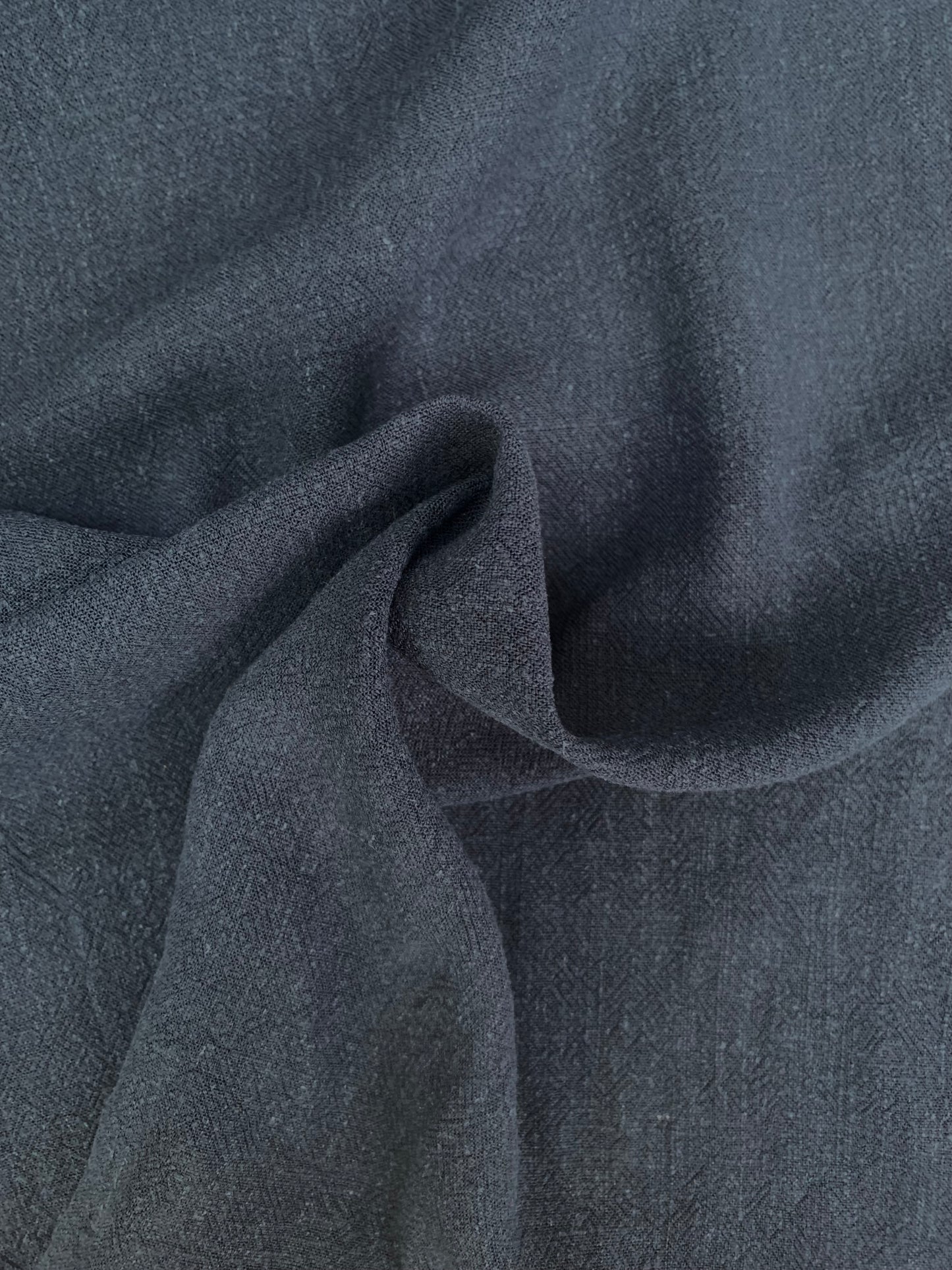 Navy sand-washed fabric shown in soft folded close-up.