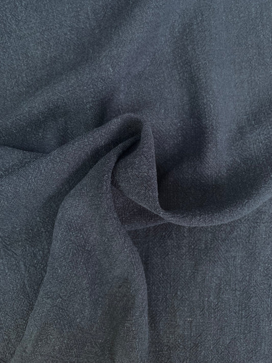 Navy sand-washed fabric shown in soft folded close-up.