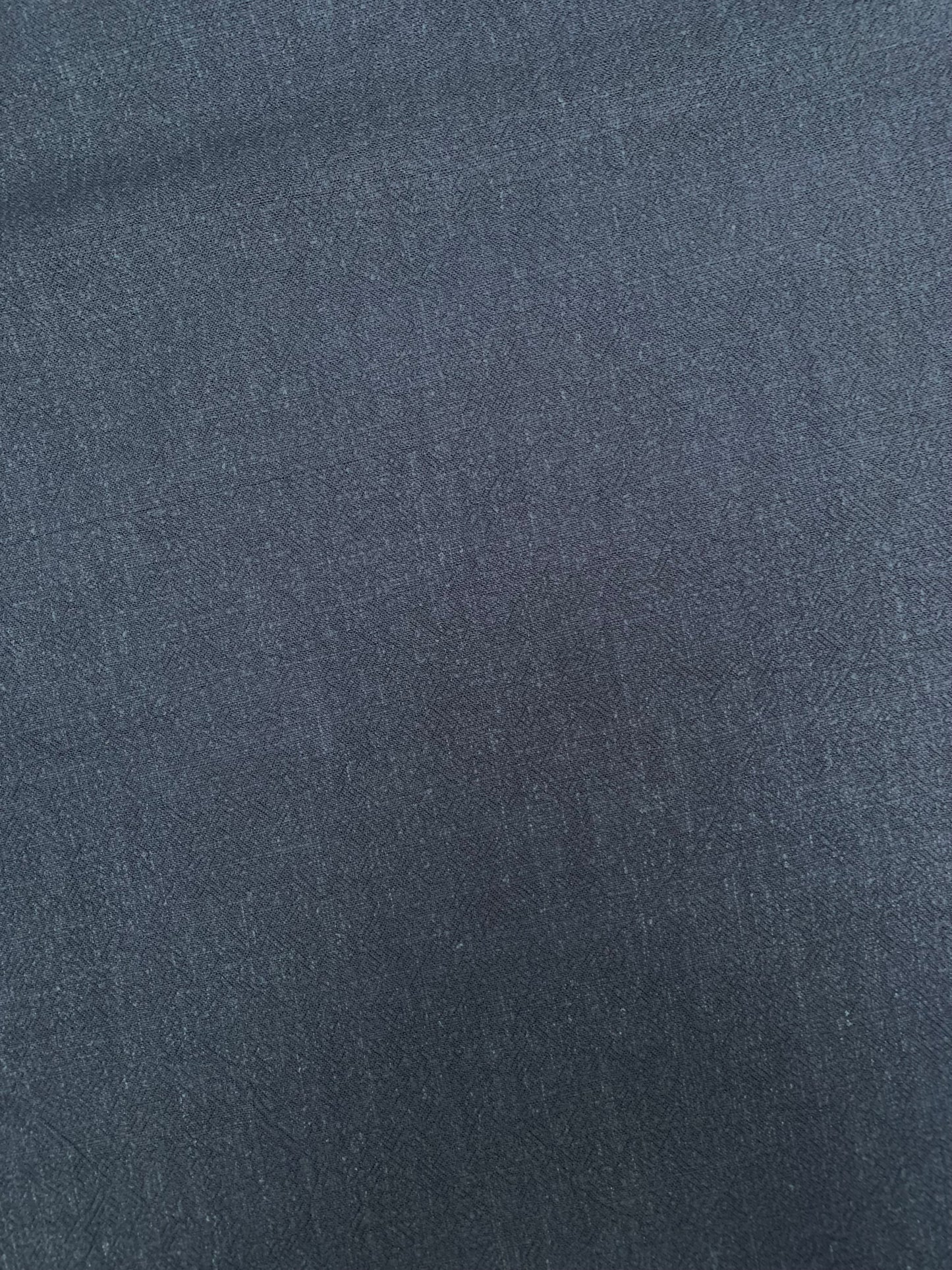Flat close-up of navy sand-washed viscose-linen blend fabric.