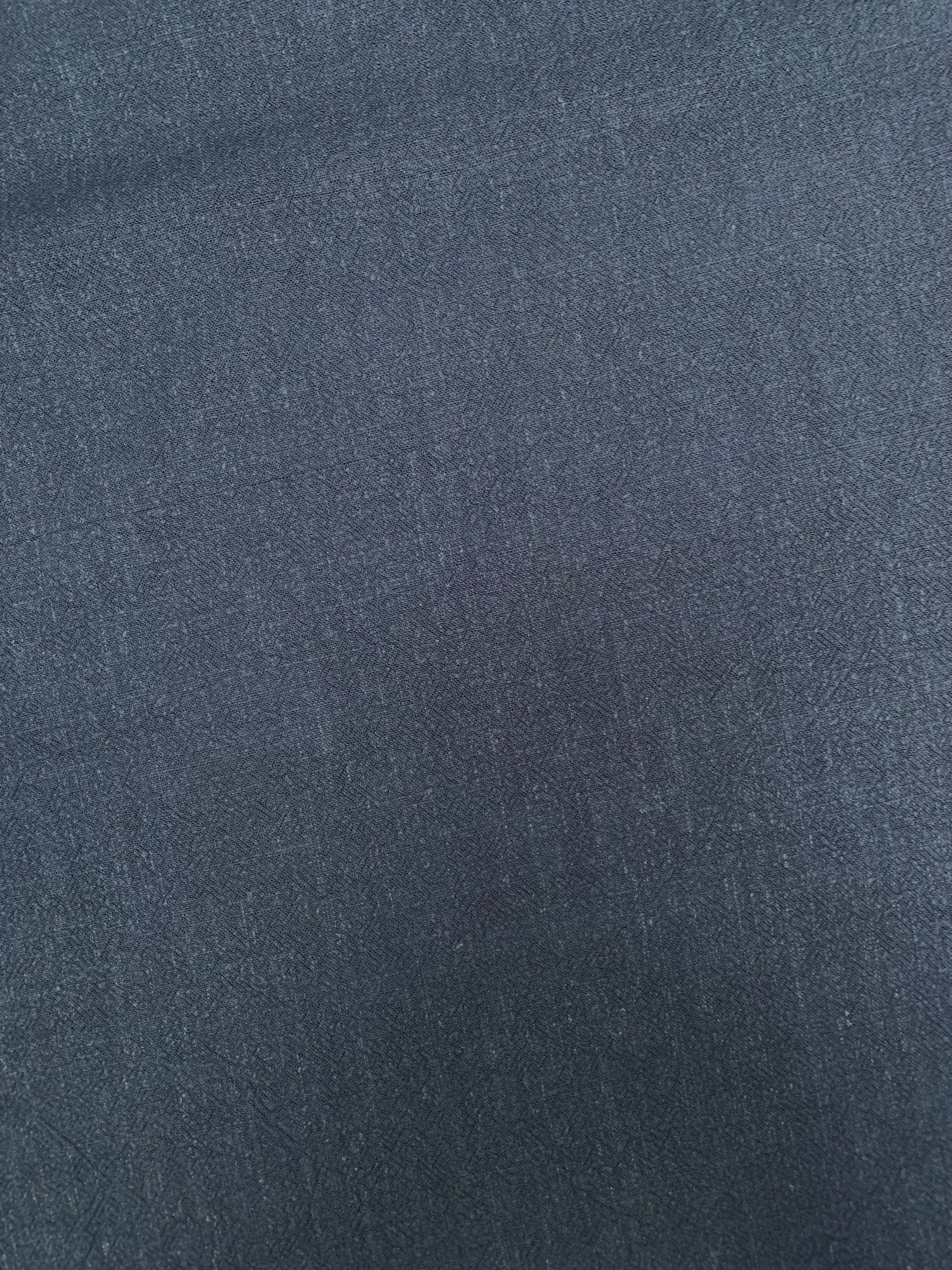 Flat close-up of navy sand-washed viscose-linen blend fabric.