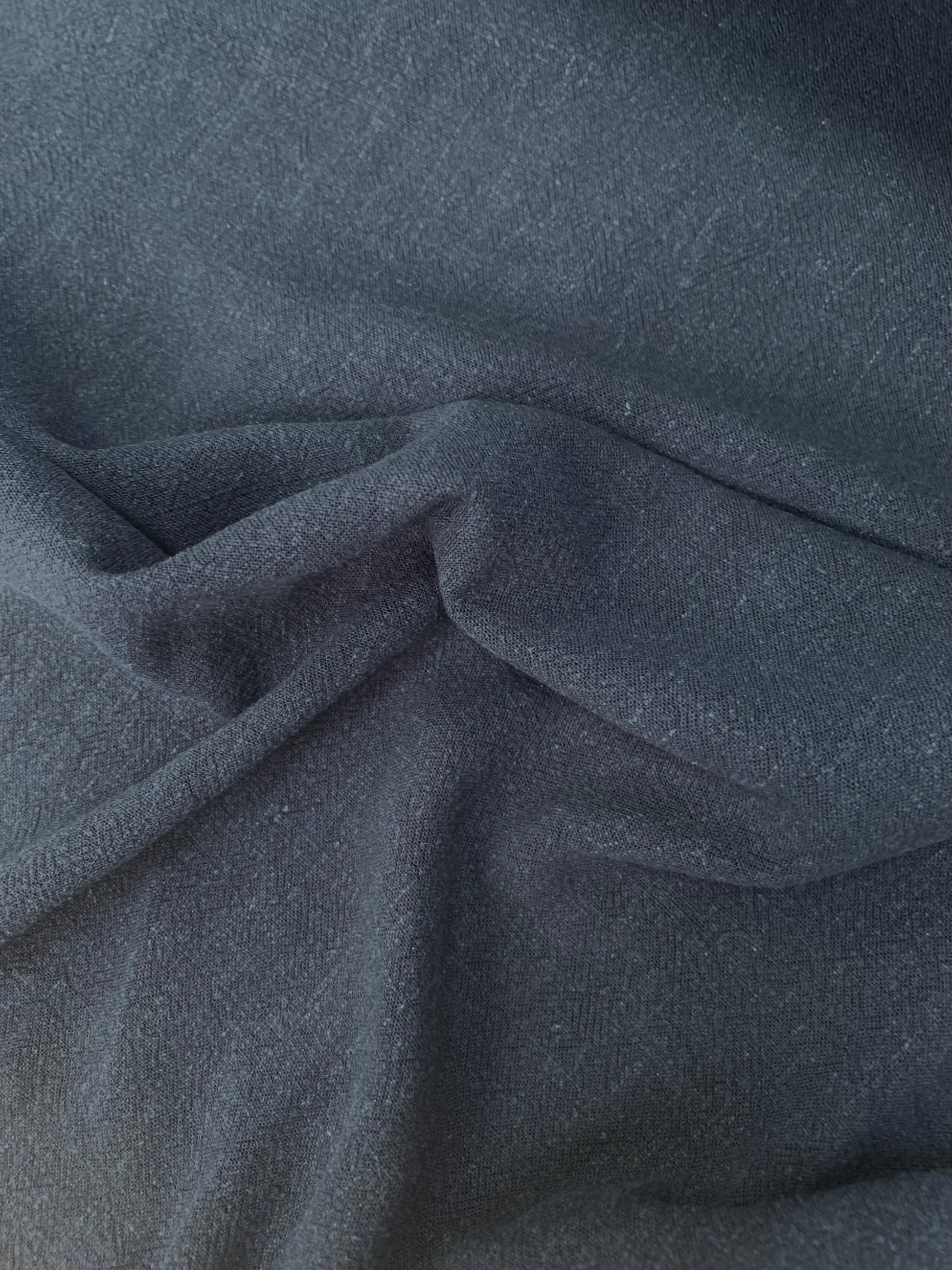 Soft folded view of navy viscose-linen blend fabric.