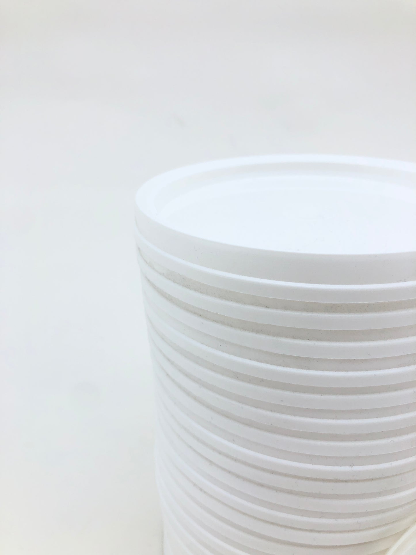 Stack of white plastic lids