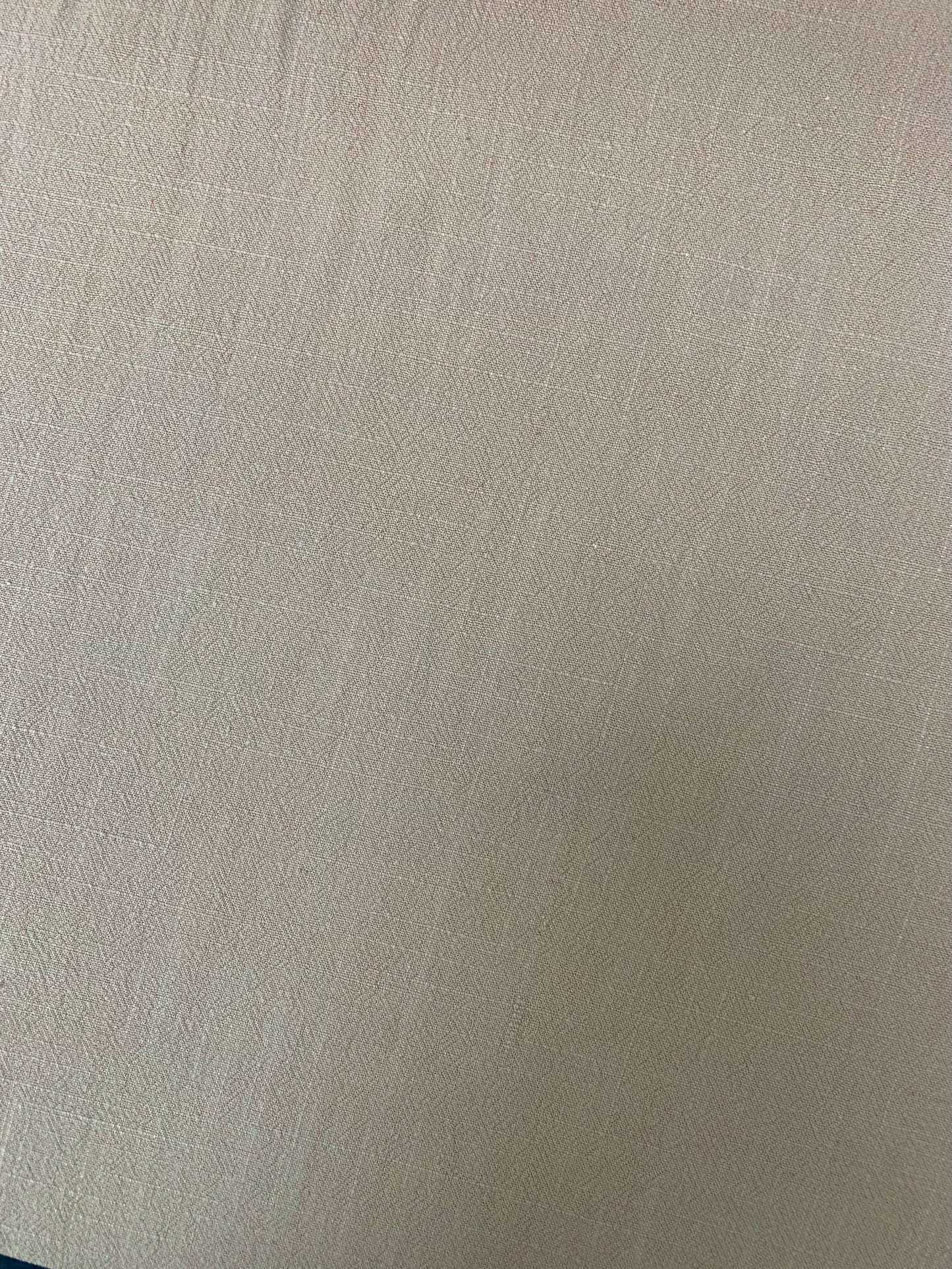 Sand-washed viscose-linen fabric shows subtle texture and creases