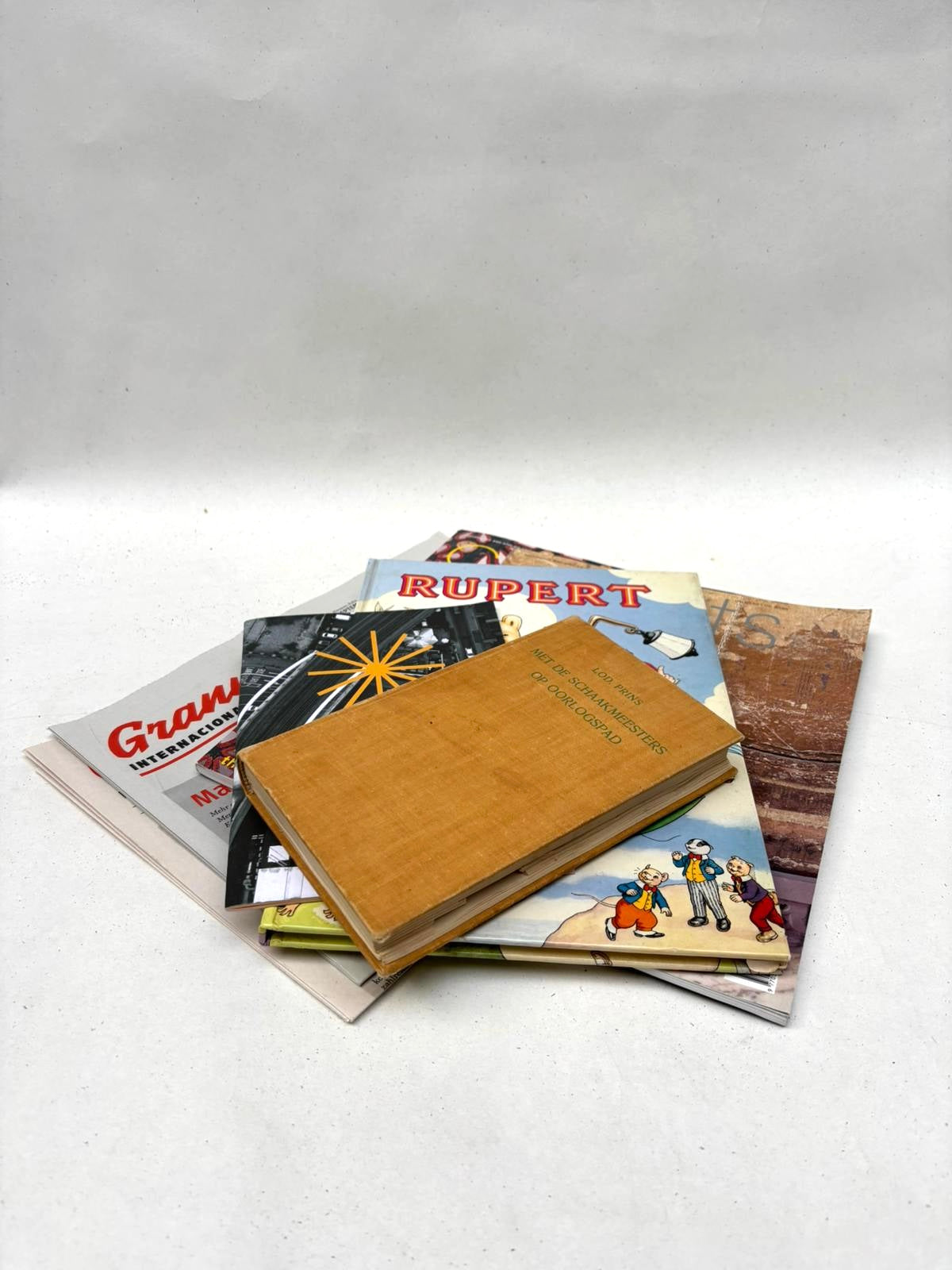A pile of printed paper materials sits on a white background
