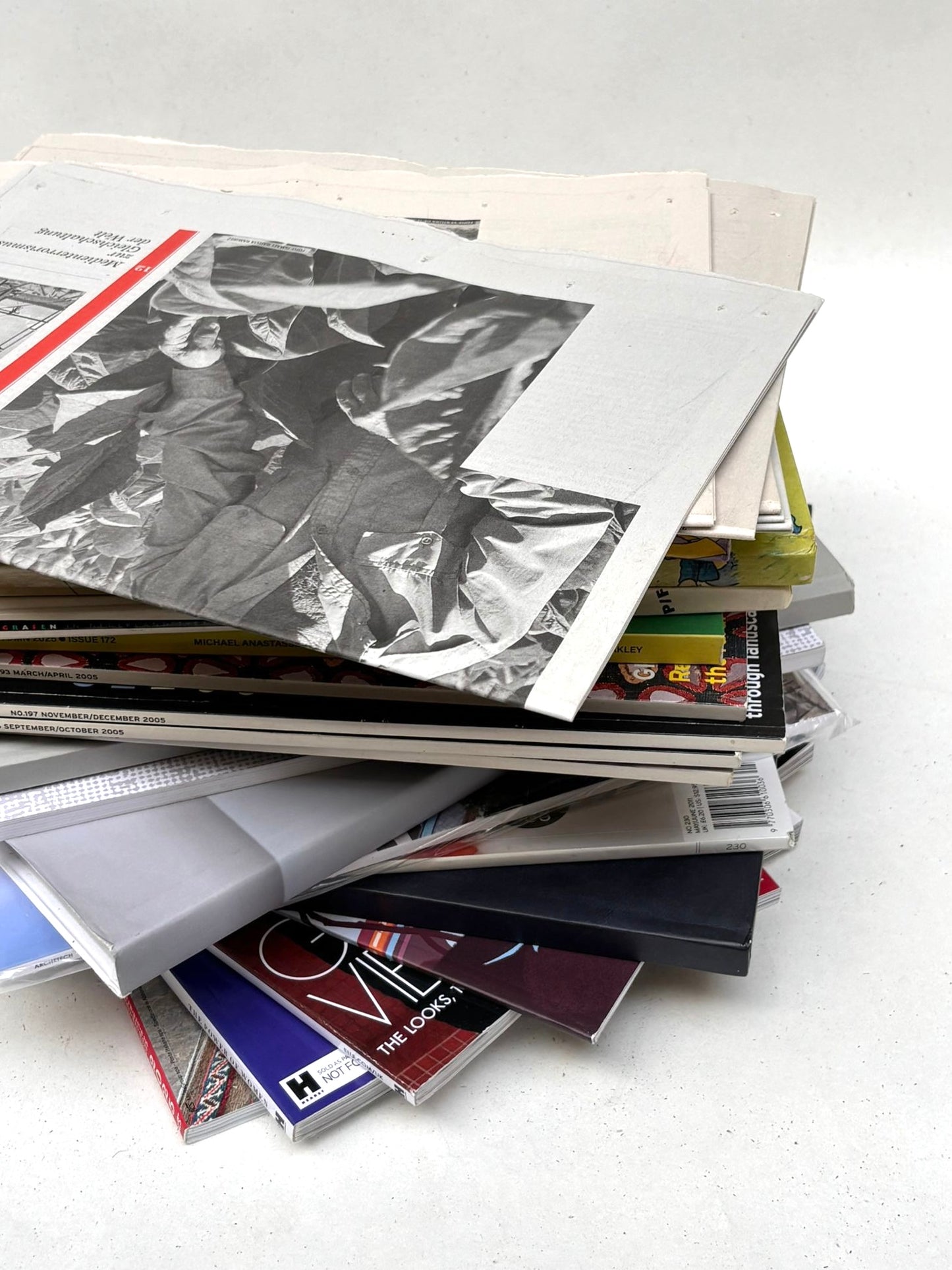 Paper items in mixed sizes are layered in a small pile