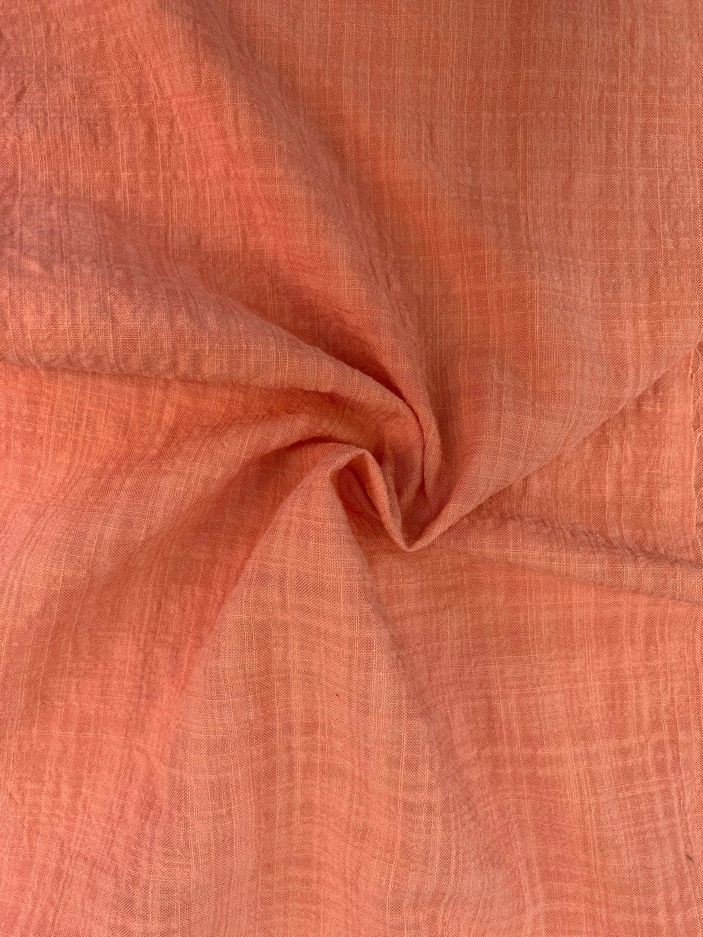 A soft peach woven fabric with a lightly crushed texture.