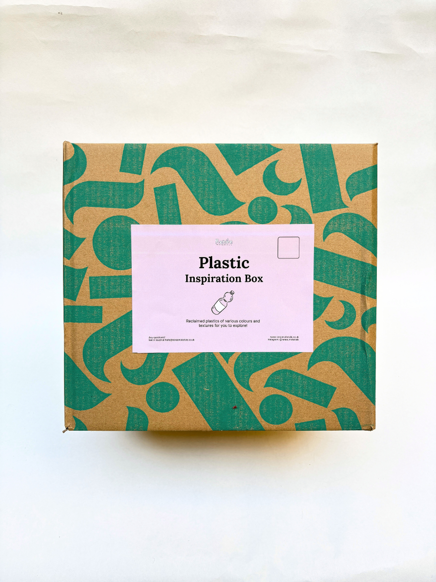 Box with green and brown pattern and a pink label on a white background