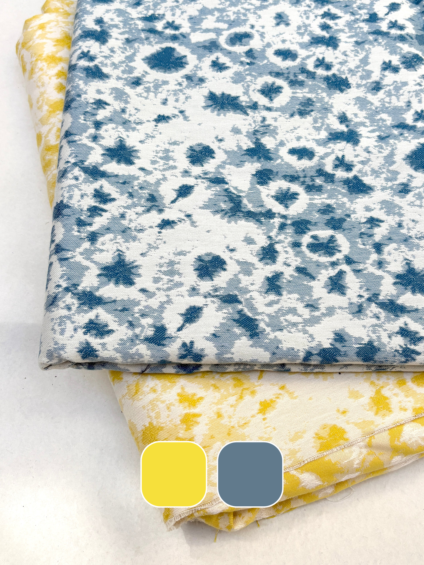 Folded cotton fabric with blue and white pattern on a white background