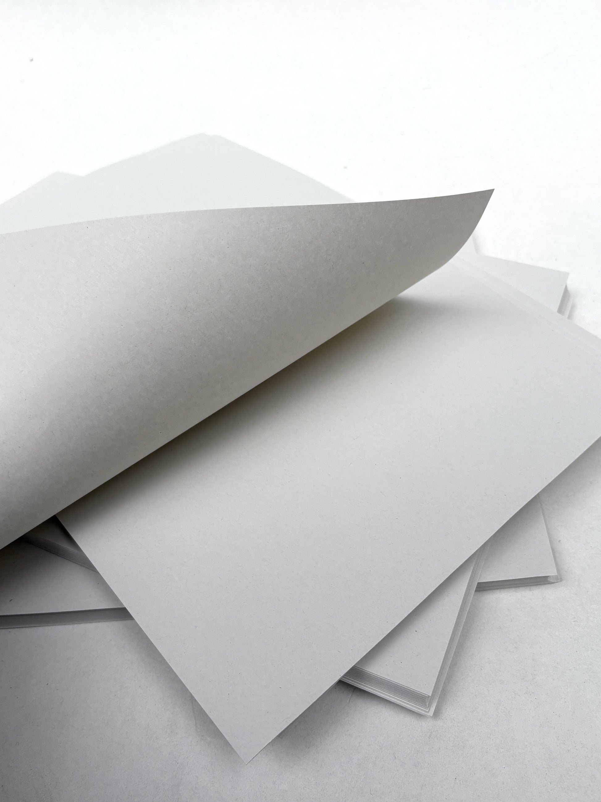 Several printer paper packs are stacked together on a white background