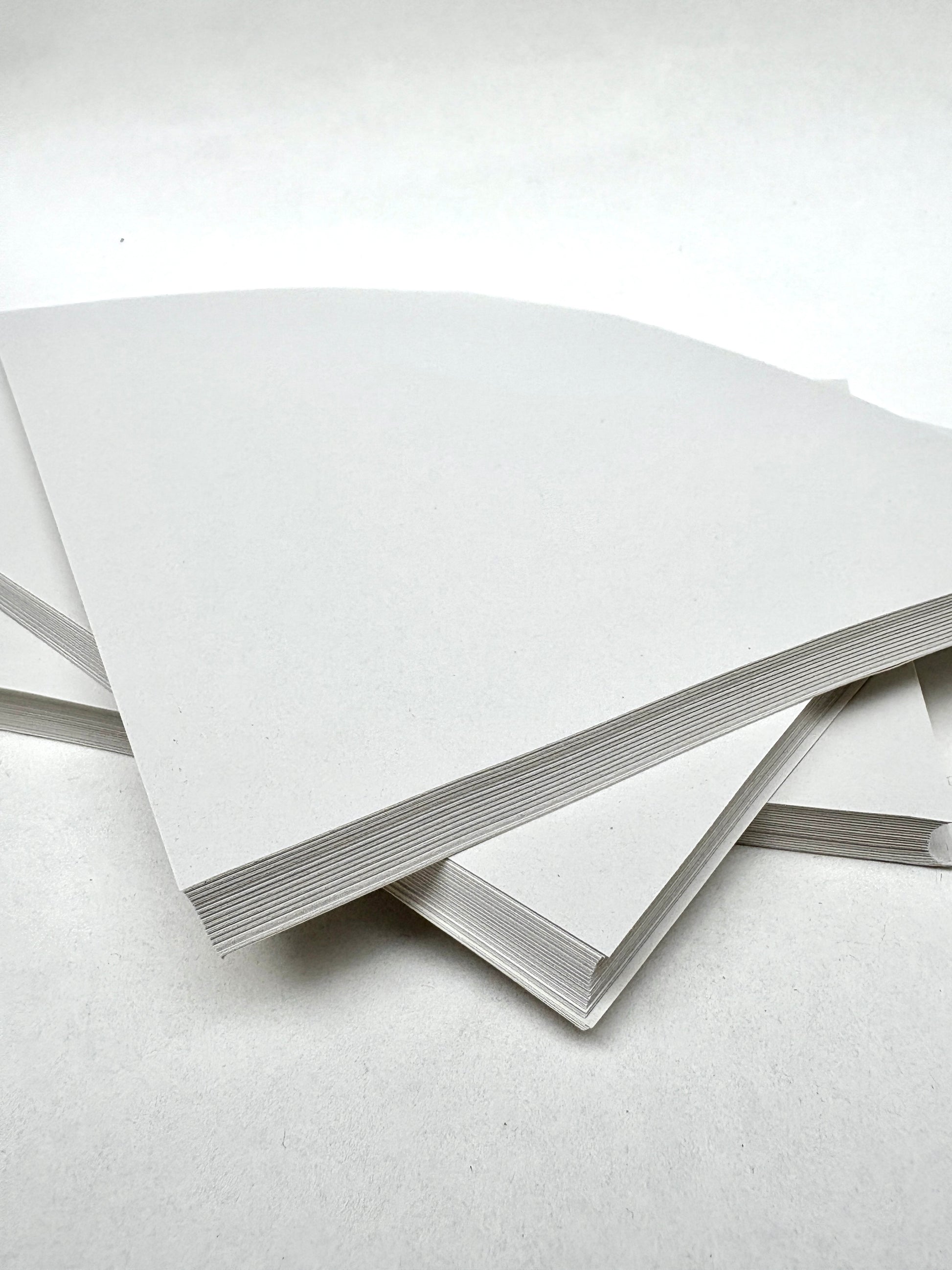 White wrapped paper are layered on a white surface