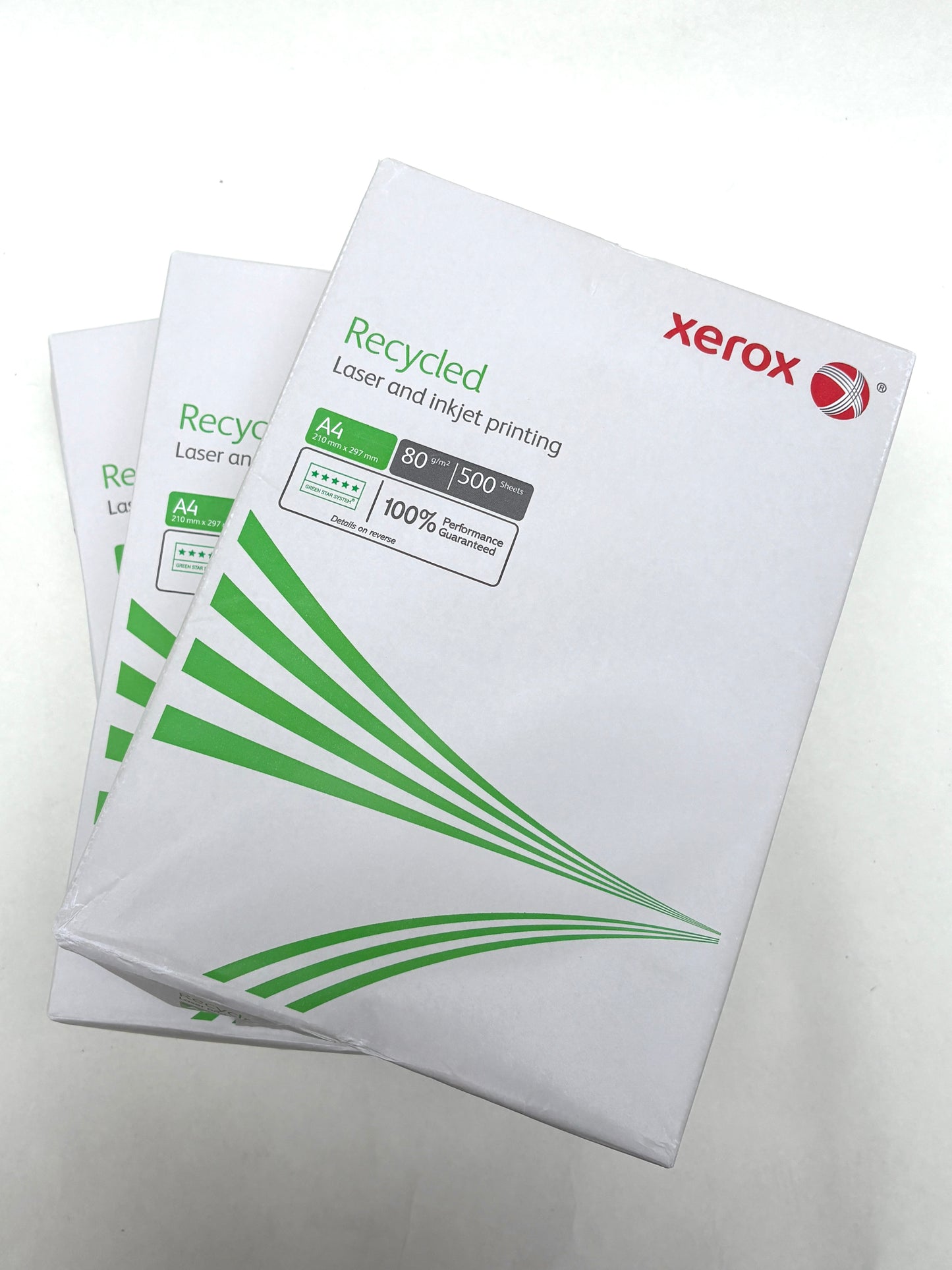 White wrapped paper packs are layered on a white surface