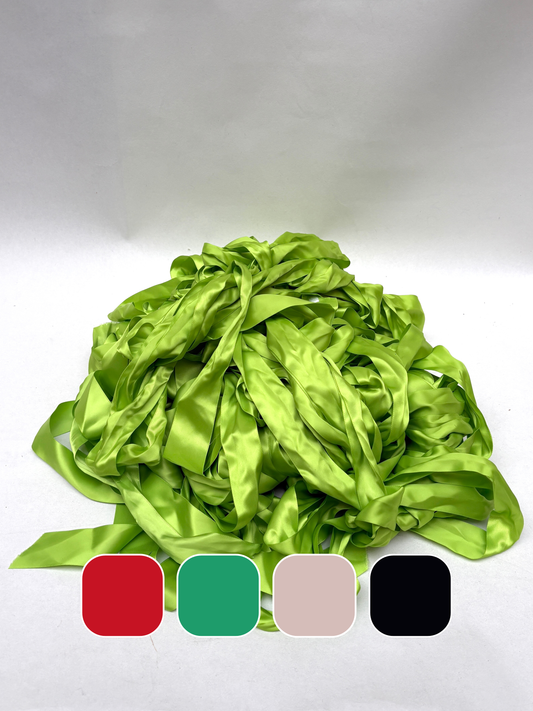 Pile of bright green satin ribbon with colour swatches on white background.