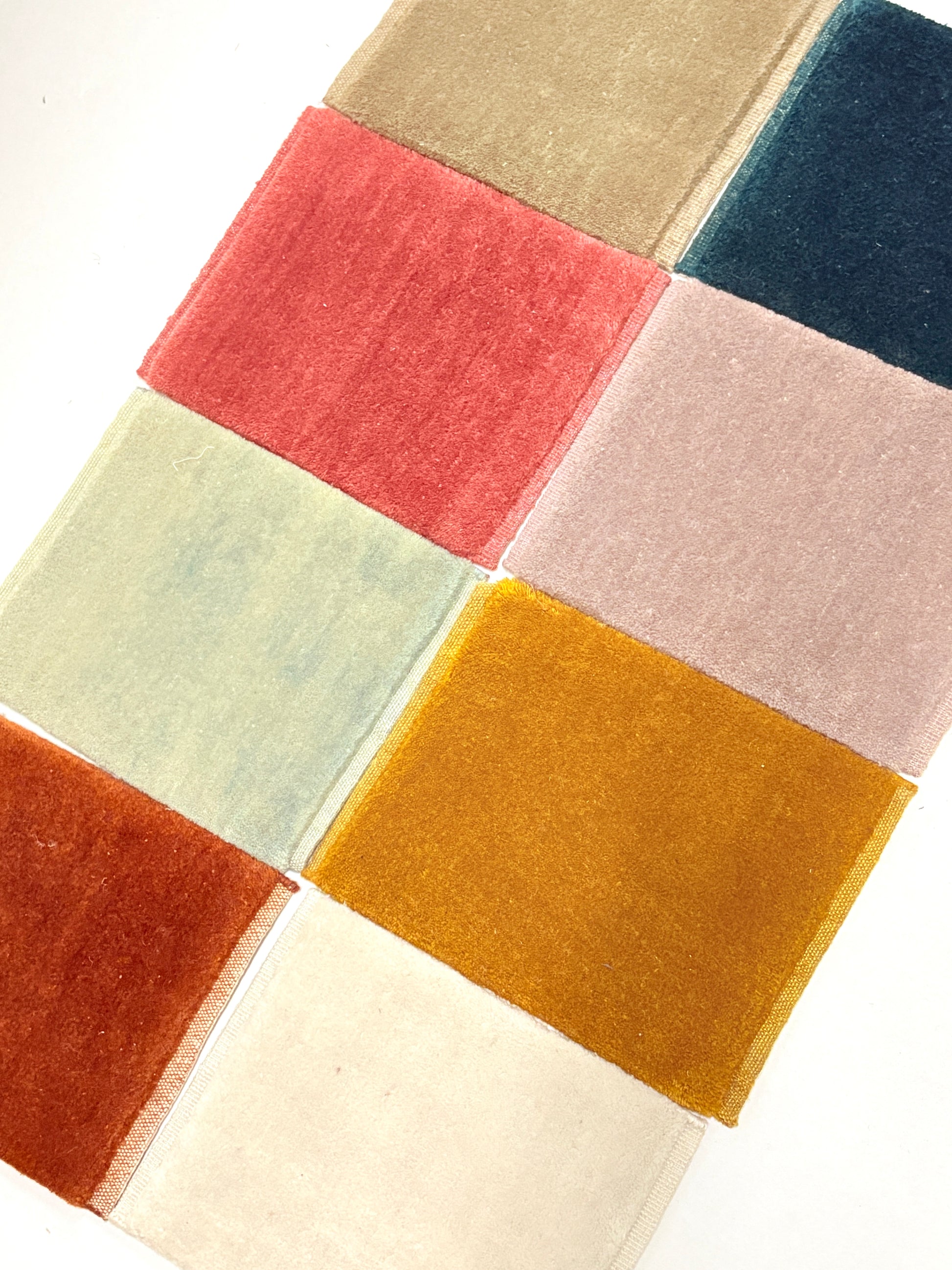 Velvet fabric swatches in assorted colours arranged in a neat grid.