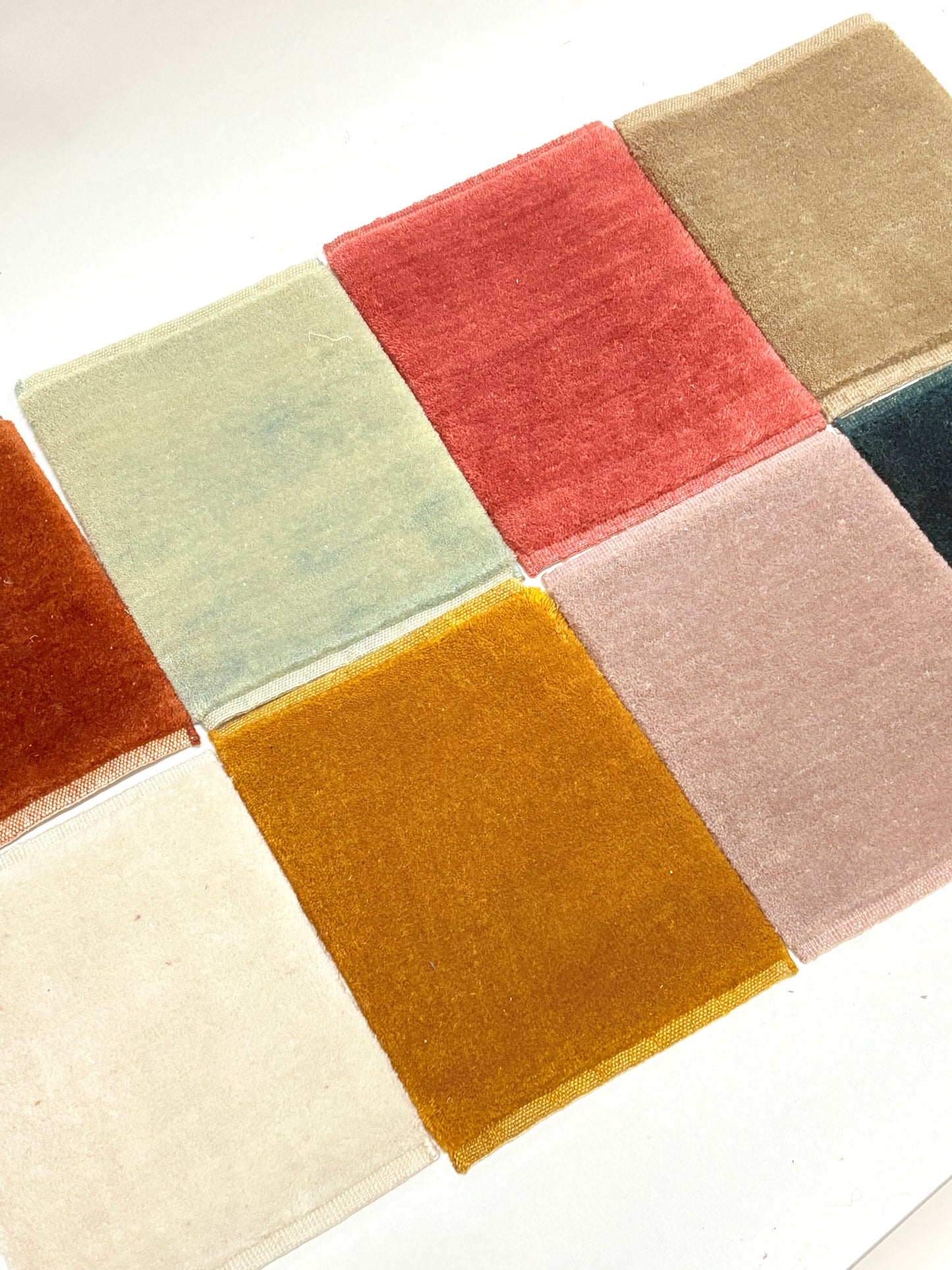 Velvet fabric swatches in a range of colours arranged in a tidy grid.