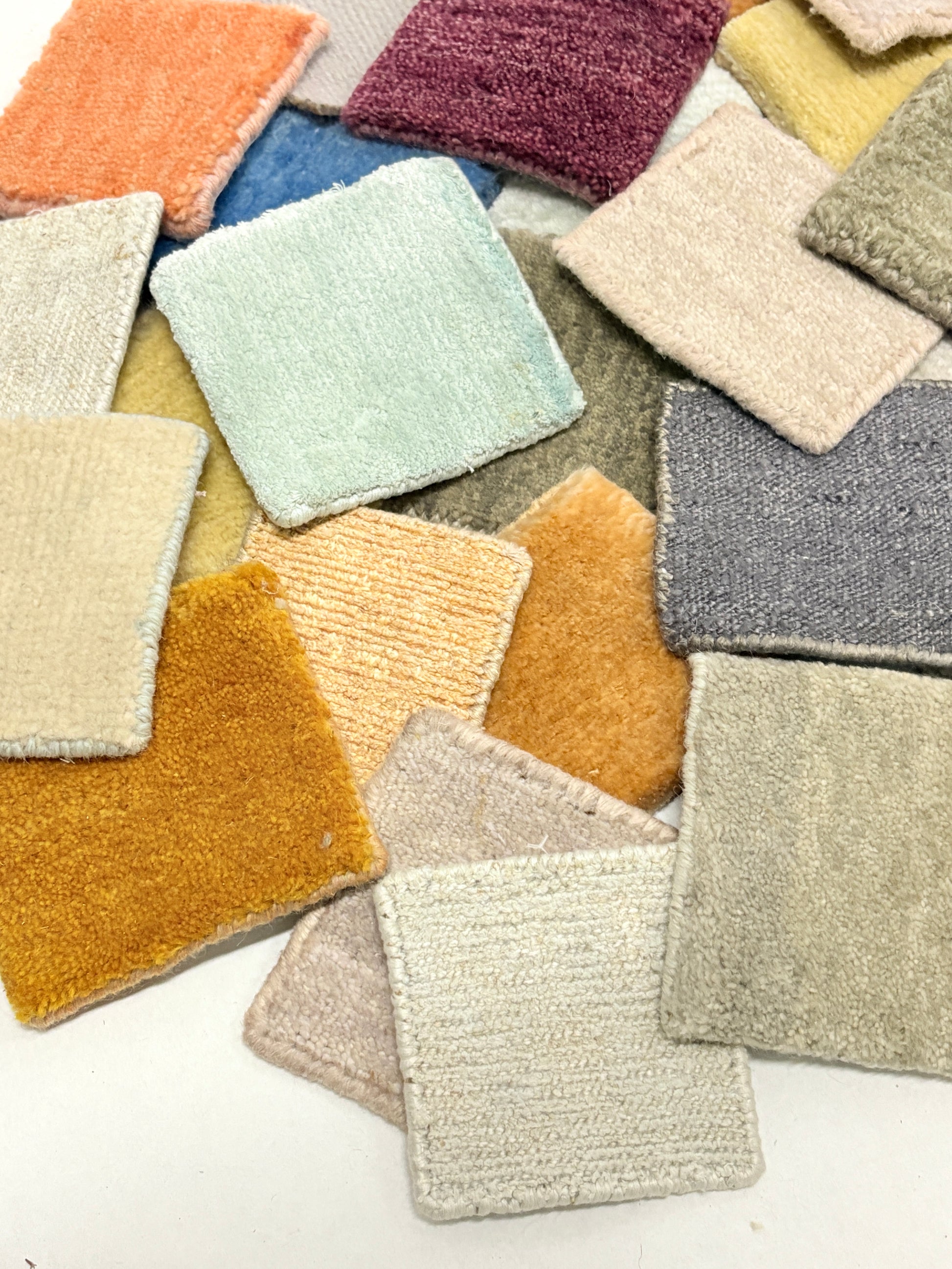 Assorted velvet fabric swatches in mixed colours and plush textures on white.