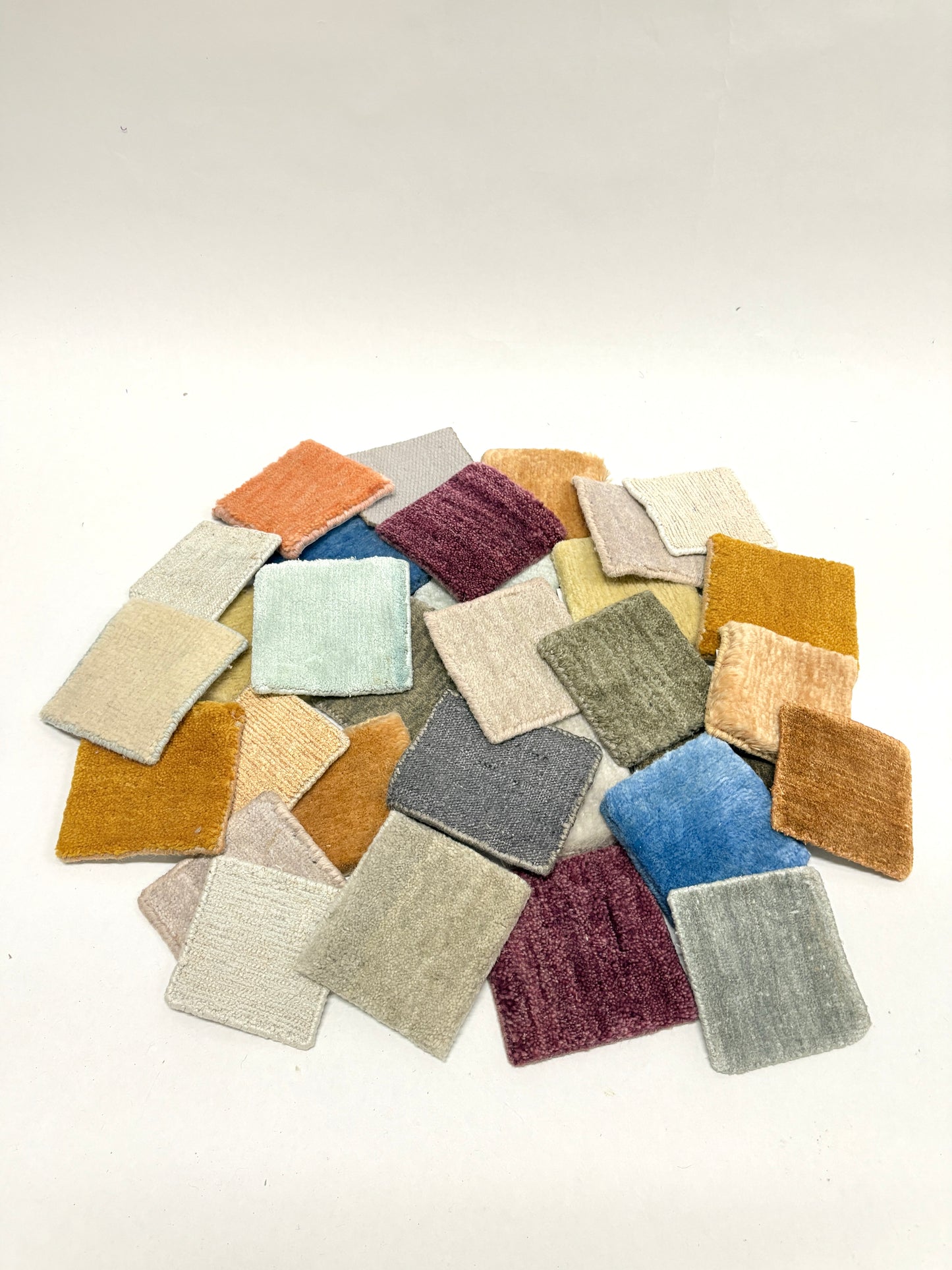 Assorted velvet fabric swatches in mixed colours on a white background.