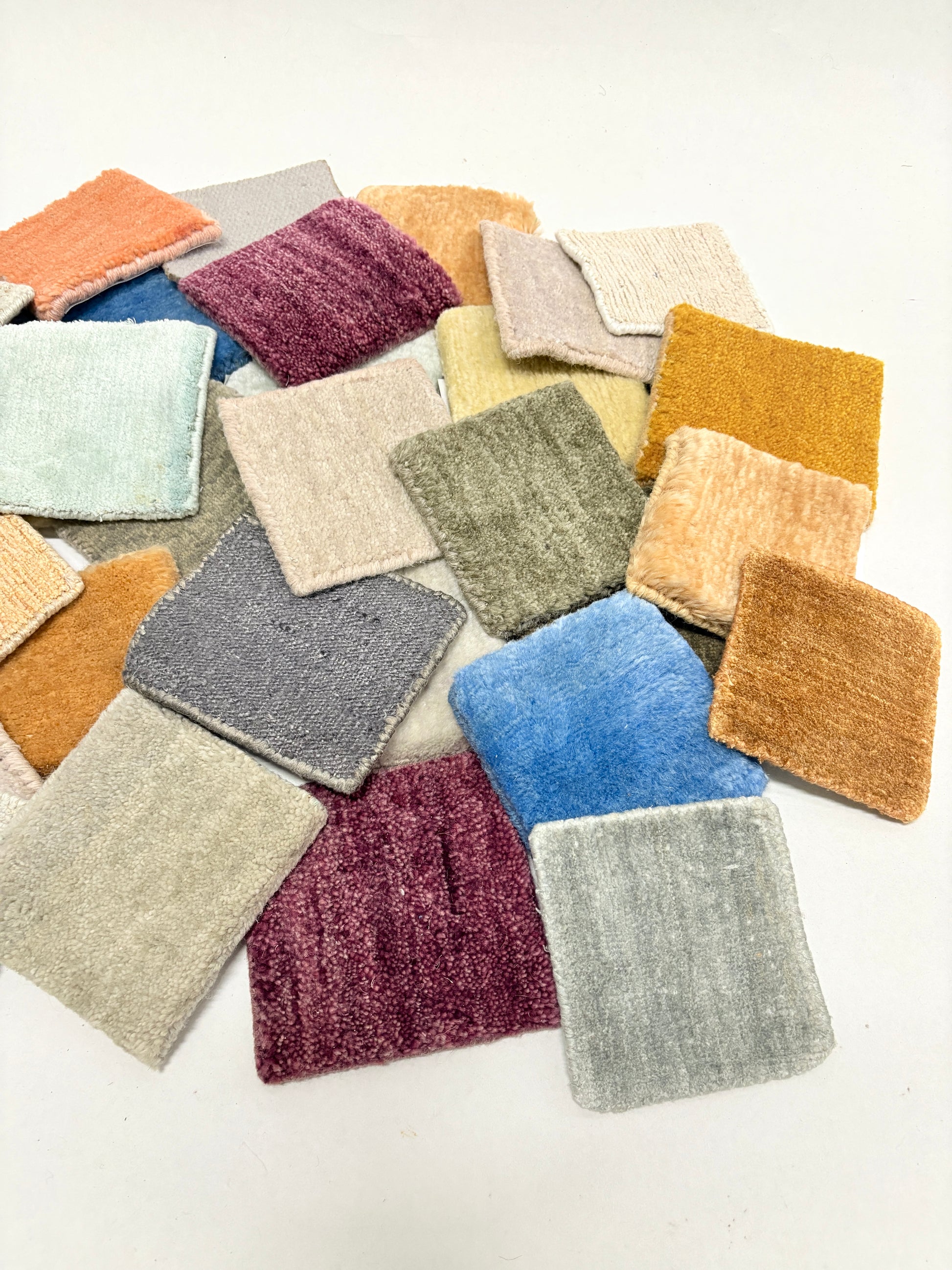 Velvet fabric swatches in assorted colours arranged on a white background.