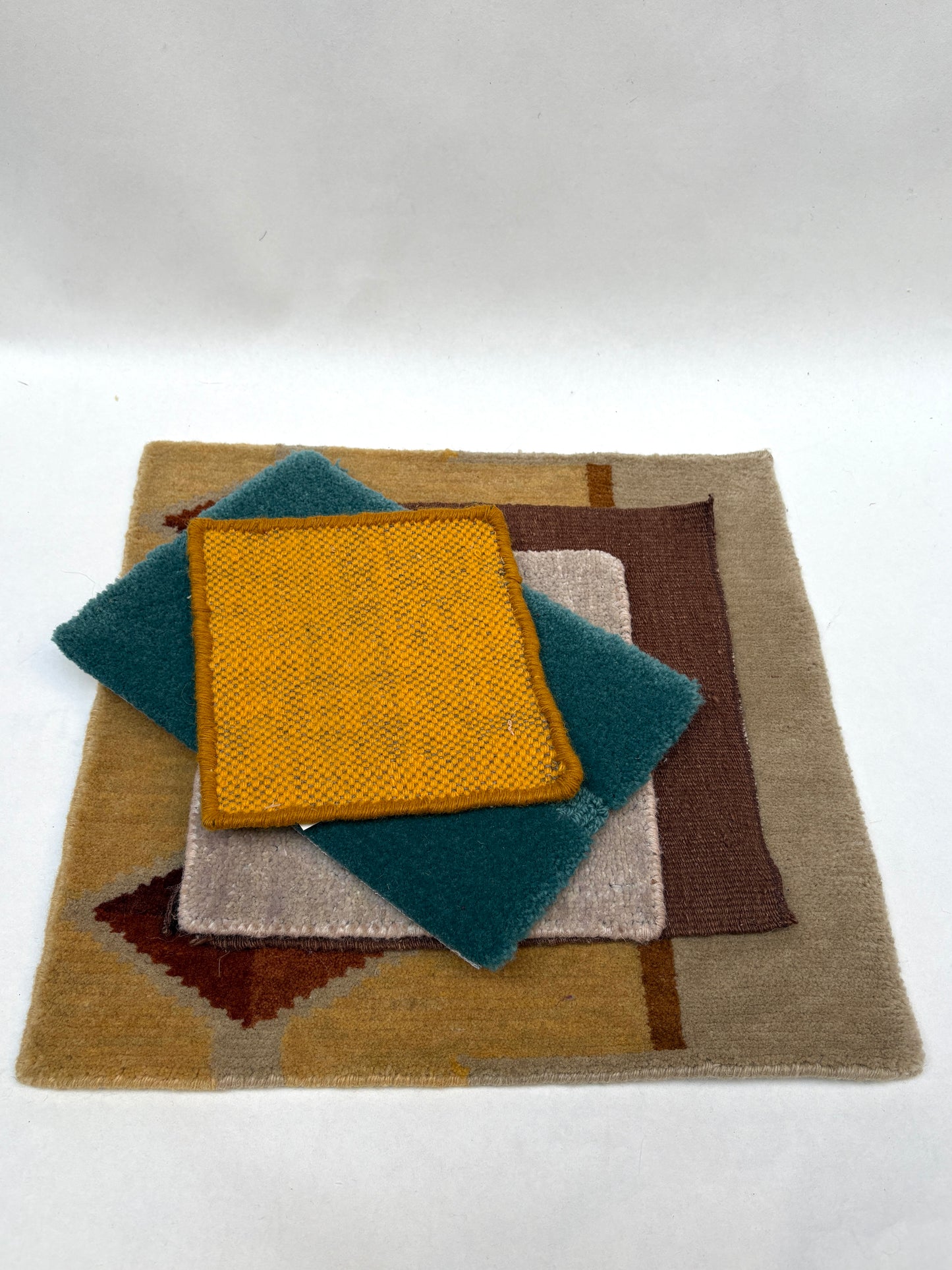 Assorted textured sample pieces are layered in a neat pile