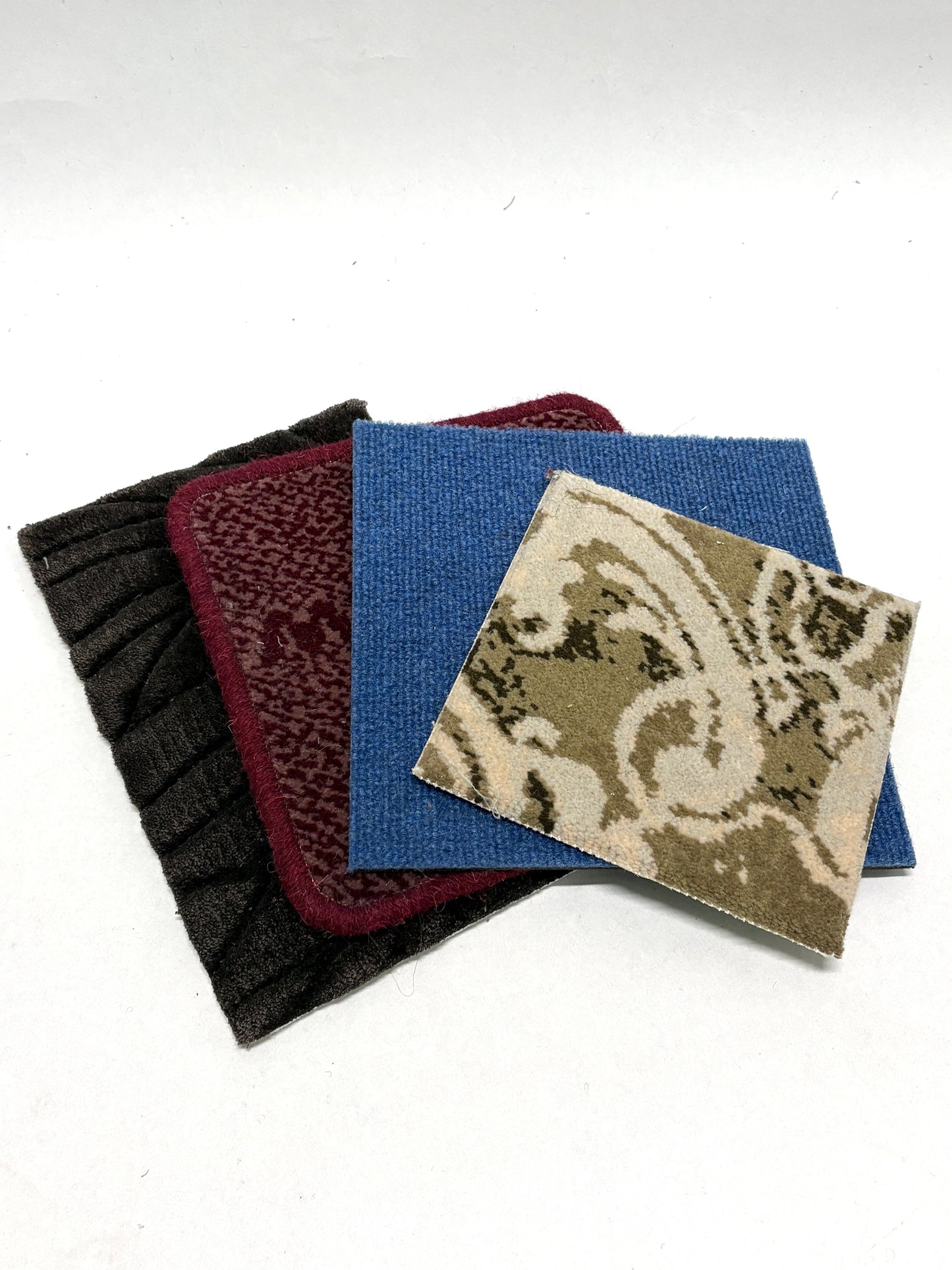 Assorted textured sample pieces are layered in a neat pile