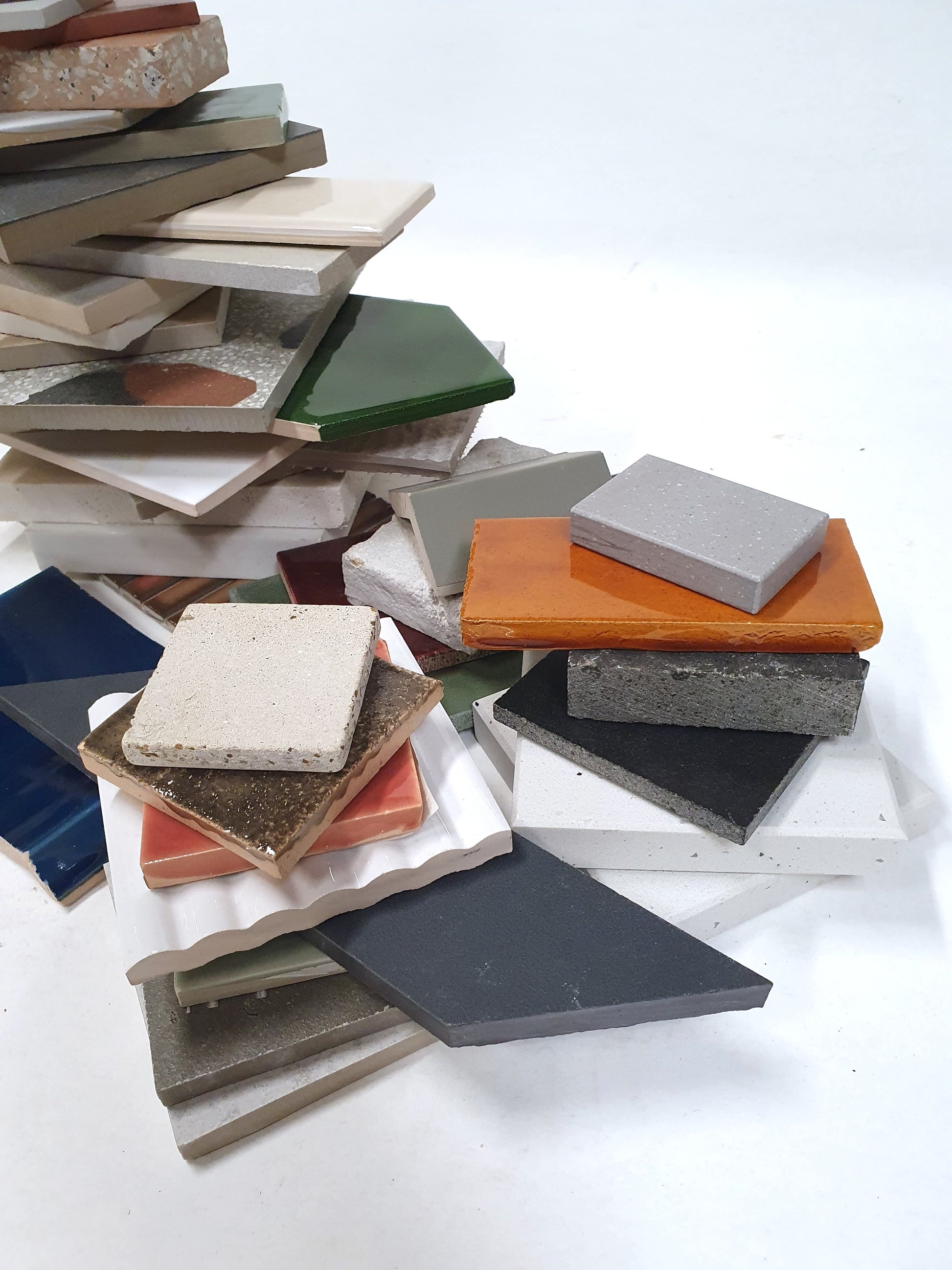 Assorted roofing and surface samples are layered in a loose pile