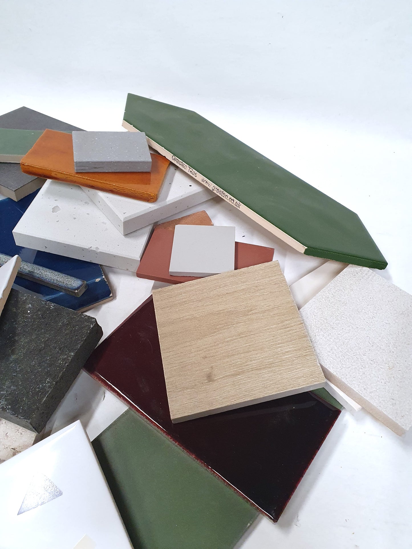 Close-up view shows mixed sample pieces in different colours and finishes