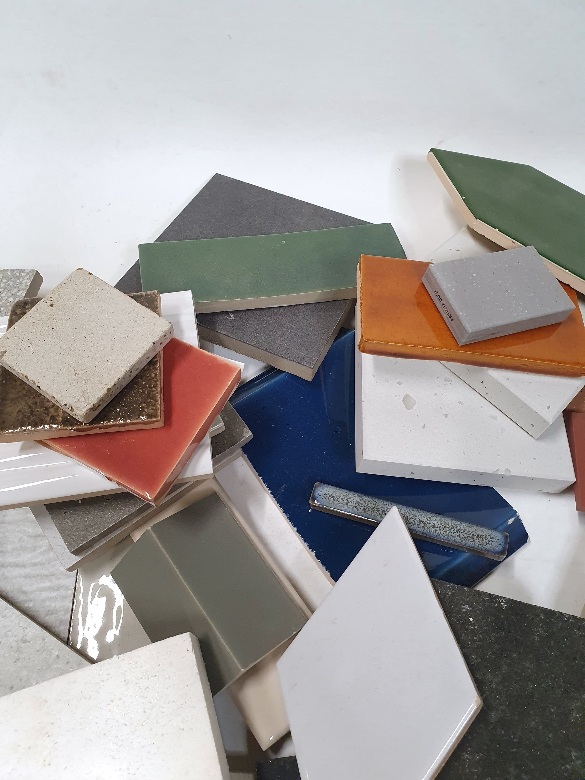 Material offcuts are spread out in detail on a white surface