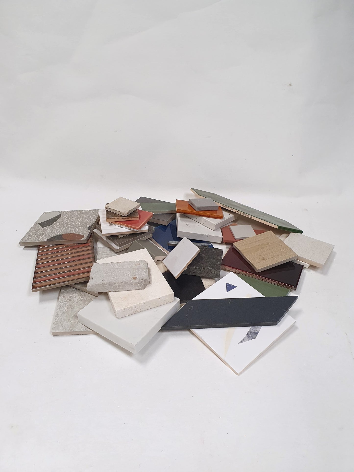 Small stacked sample pieces are shown from a distance on white