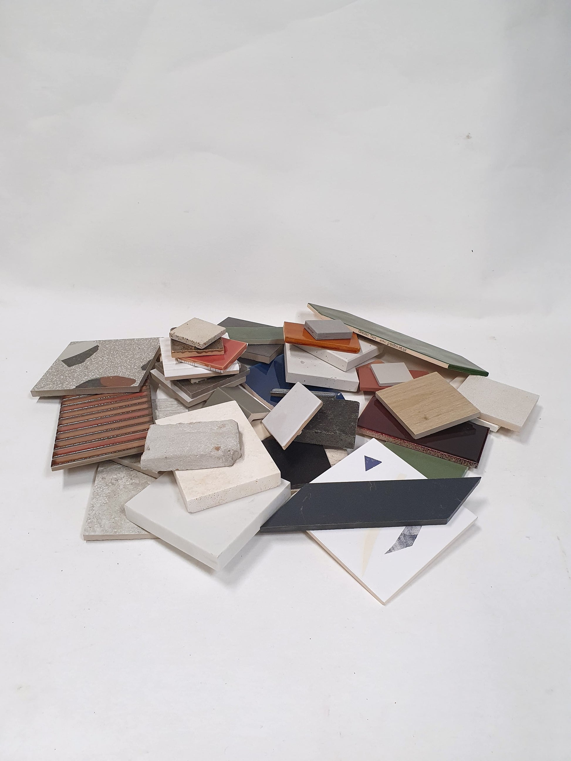 Small stacked sample pieces are shown from a distance on white