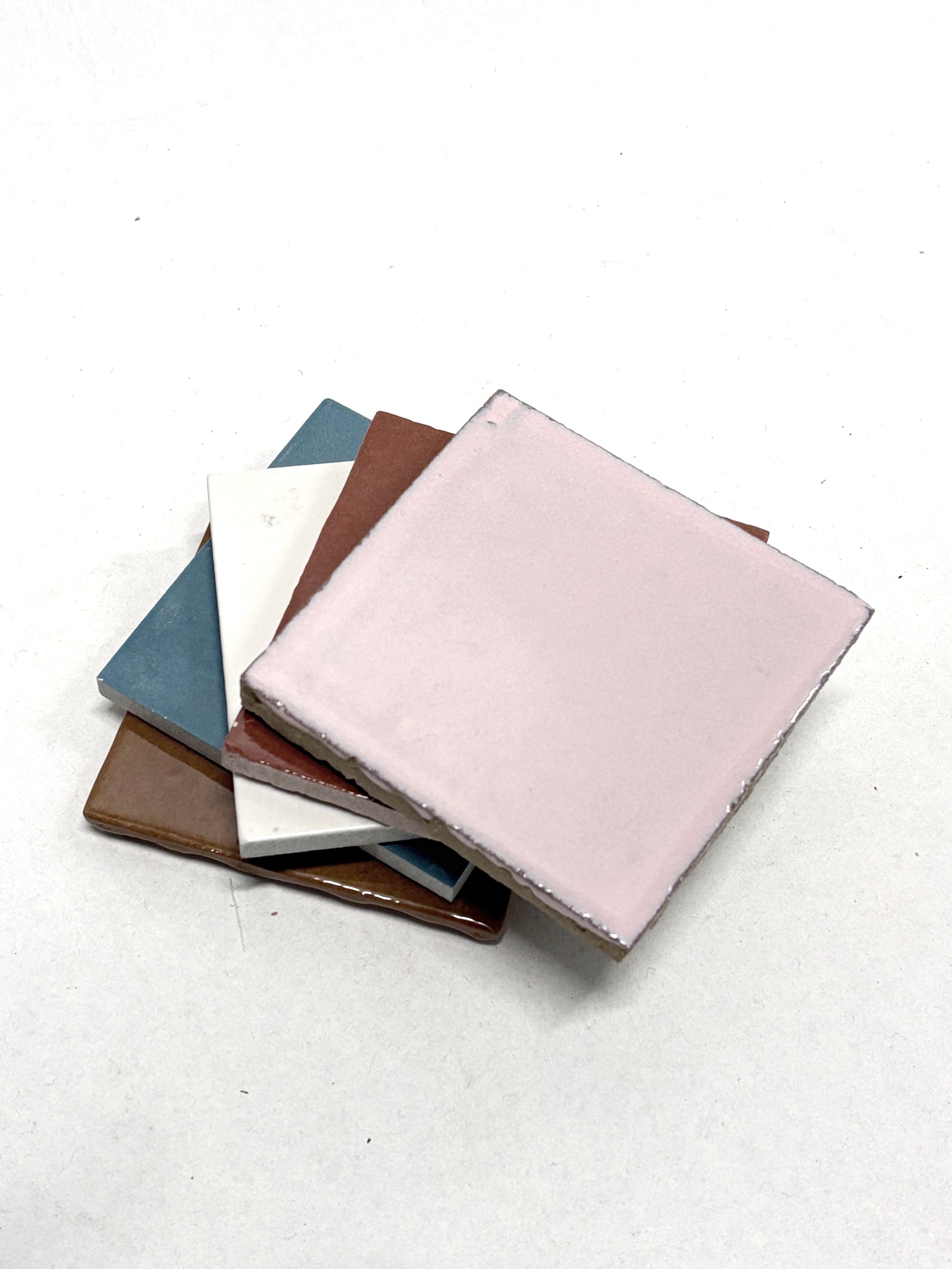 Close-up view shows layered tiles with pink, brown, and blue surfaces