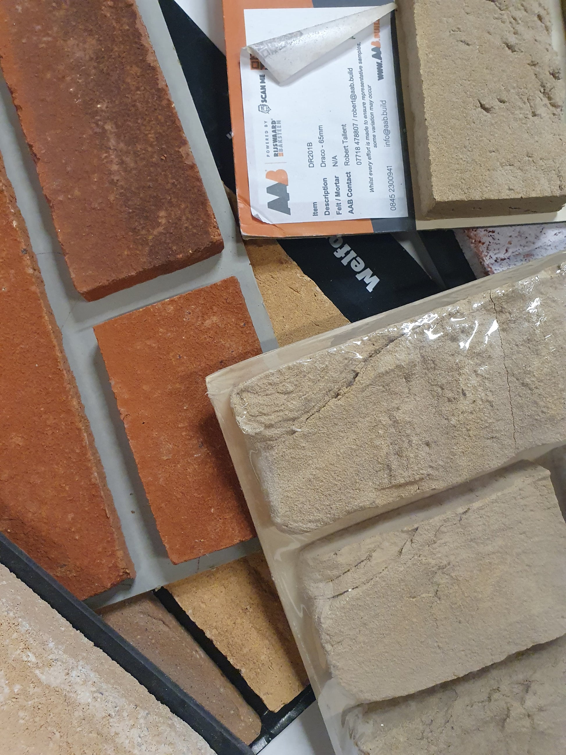 Close-up of assorted brick sample boards in red and cream tones.