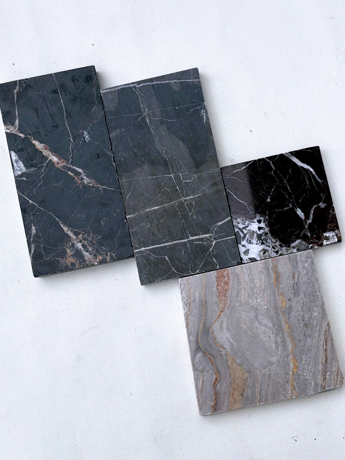 Marble-look tiles are displayed in detail from multiple angles