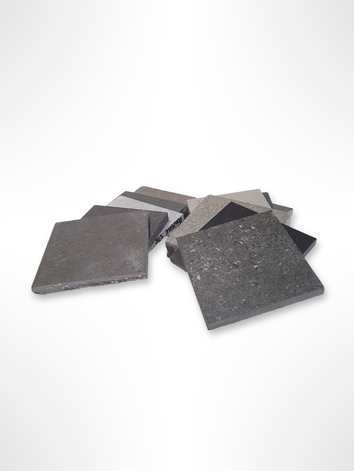 Assorted grey tile samples displayed against a plain light background.