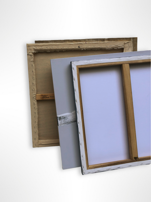 Stretched canvases and panels are leaning together on a white background