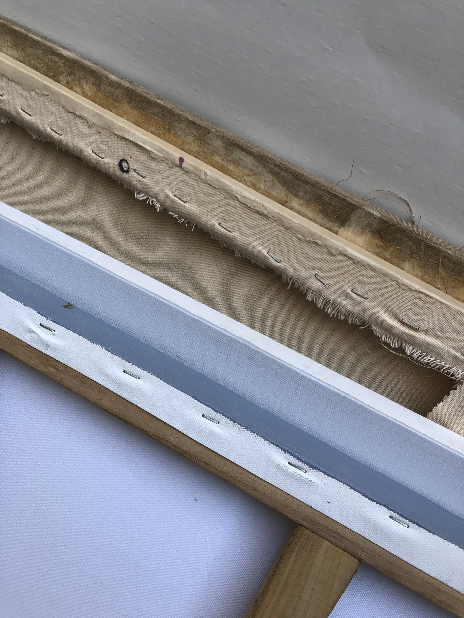 	Close-up view shows the canvas edge and wooden frame in detail