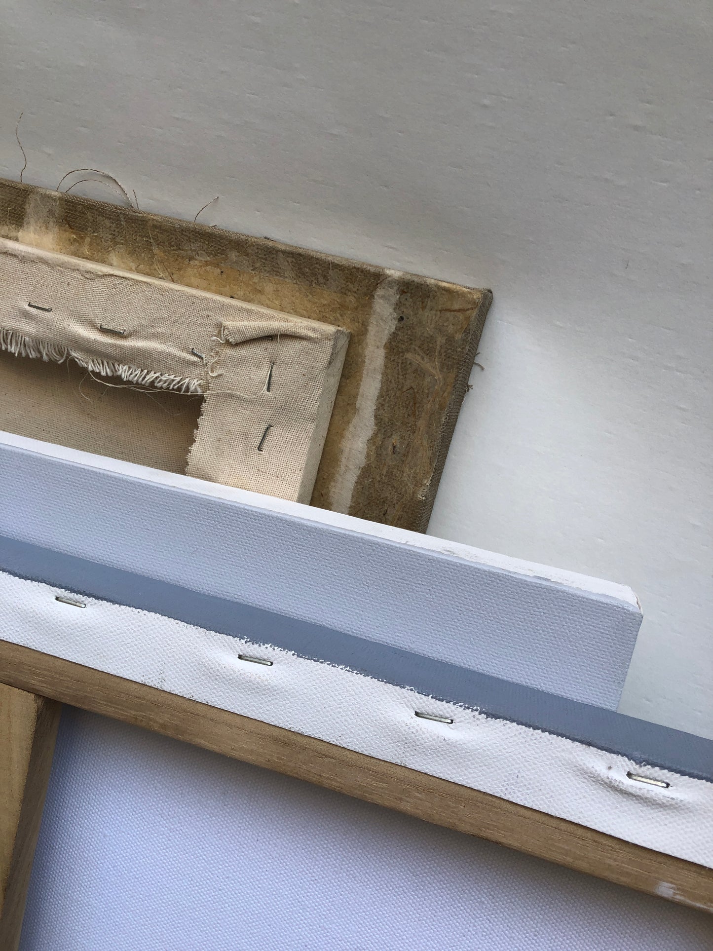 Stretched canvas corners are shown in detail with visible frame edges