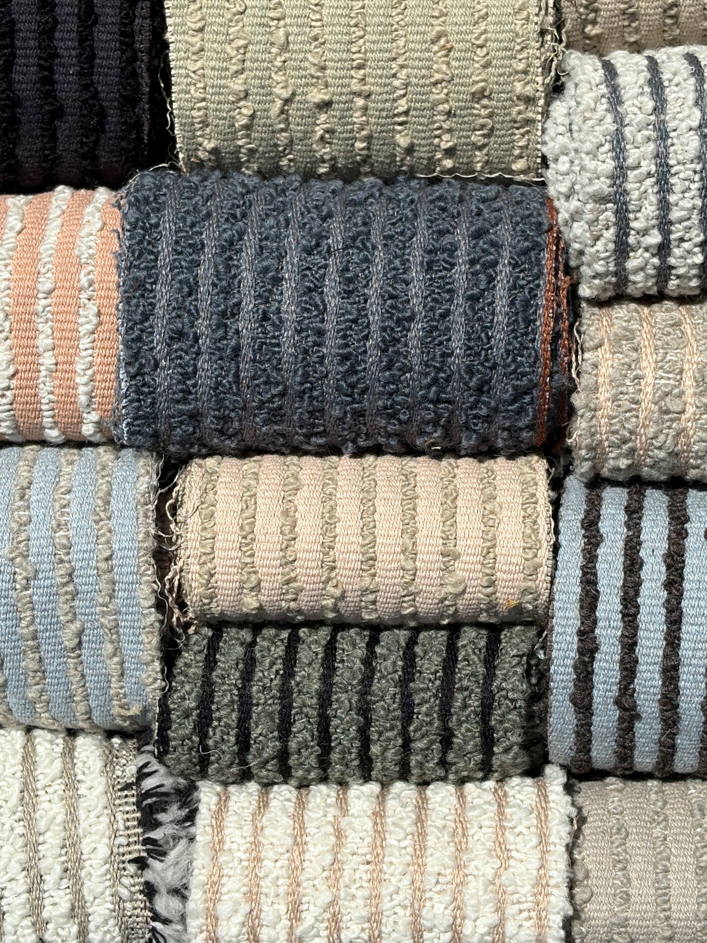 Collection of textured rugs in various colors and patterns.